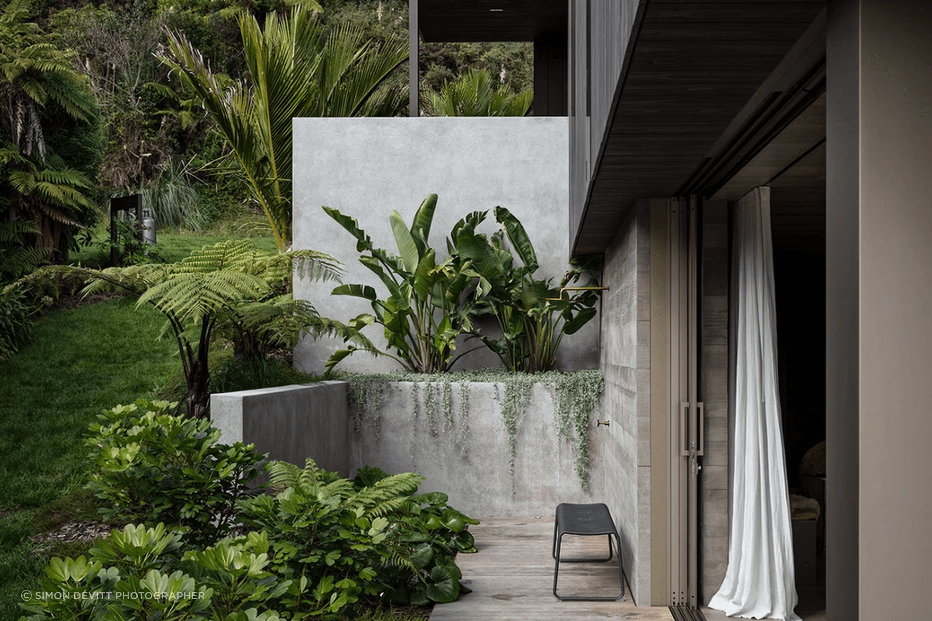 The outdoor shower. “There’s a double wall of concrete and the doors slide into a pocket between them. It looks easy, but actually building it is a real challenge,” says Evelyn. She mapped out the gardens, and Flora and Form designed and planted them.