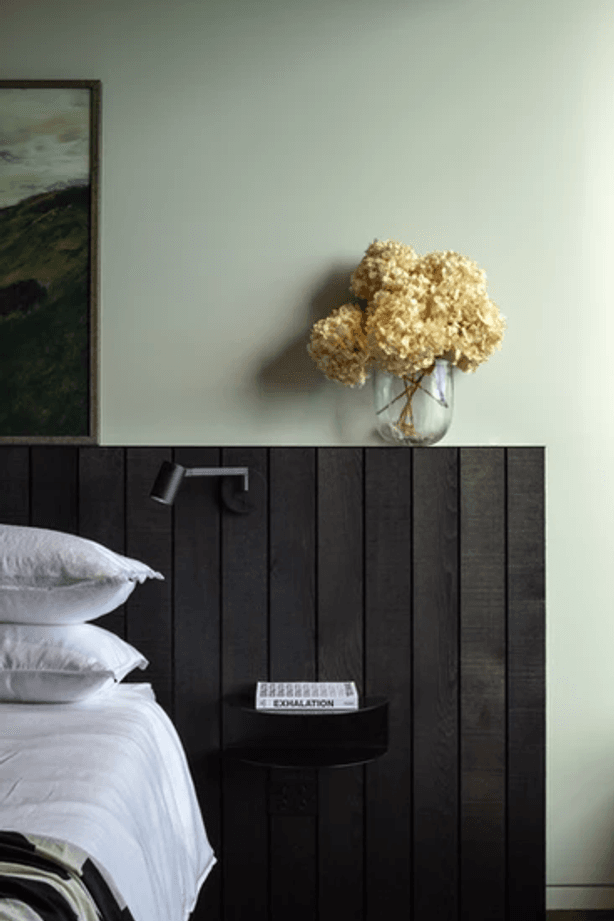One of two master bedrooms that are both oriented to the views. The side table is from Made of Tomorrow.