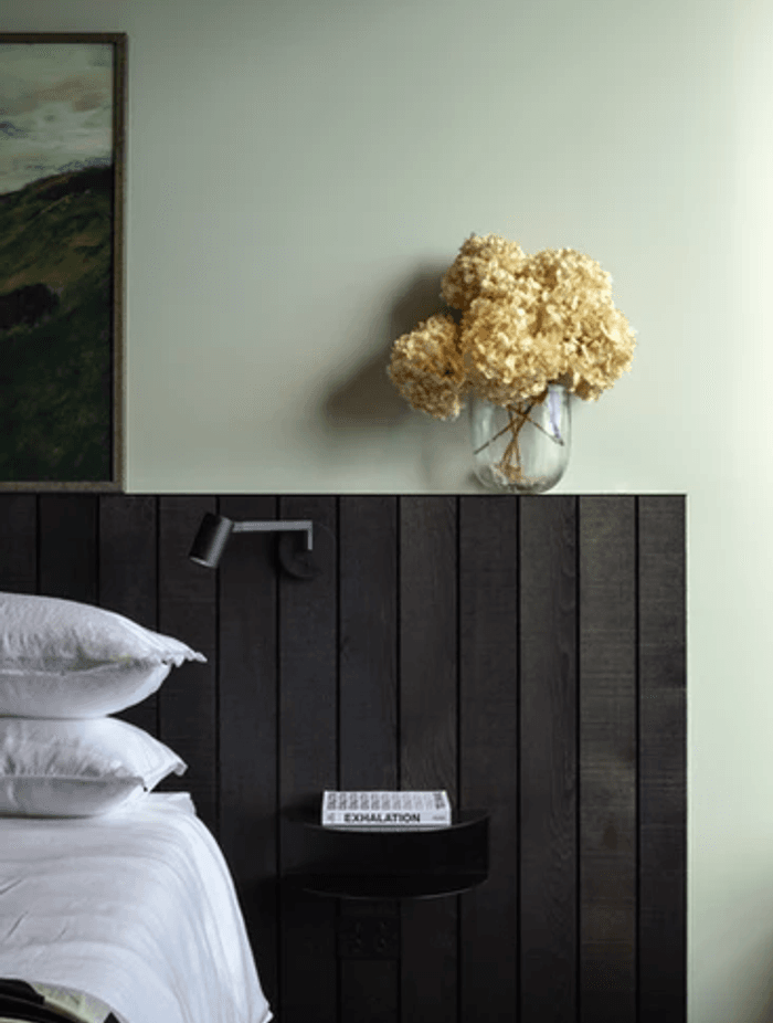 One of two master bedrooms that are both oriented to the views. The side table is from Made of Tomorrow.