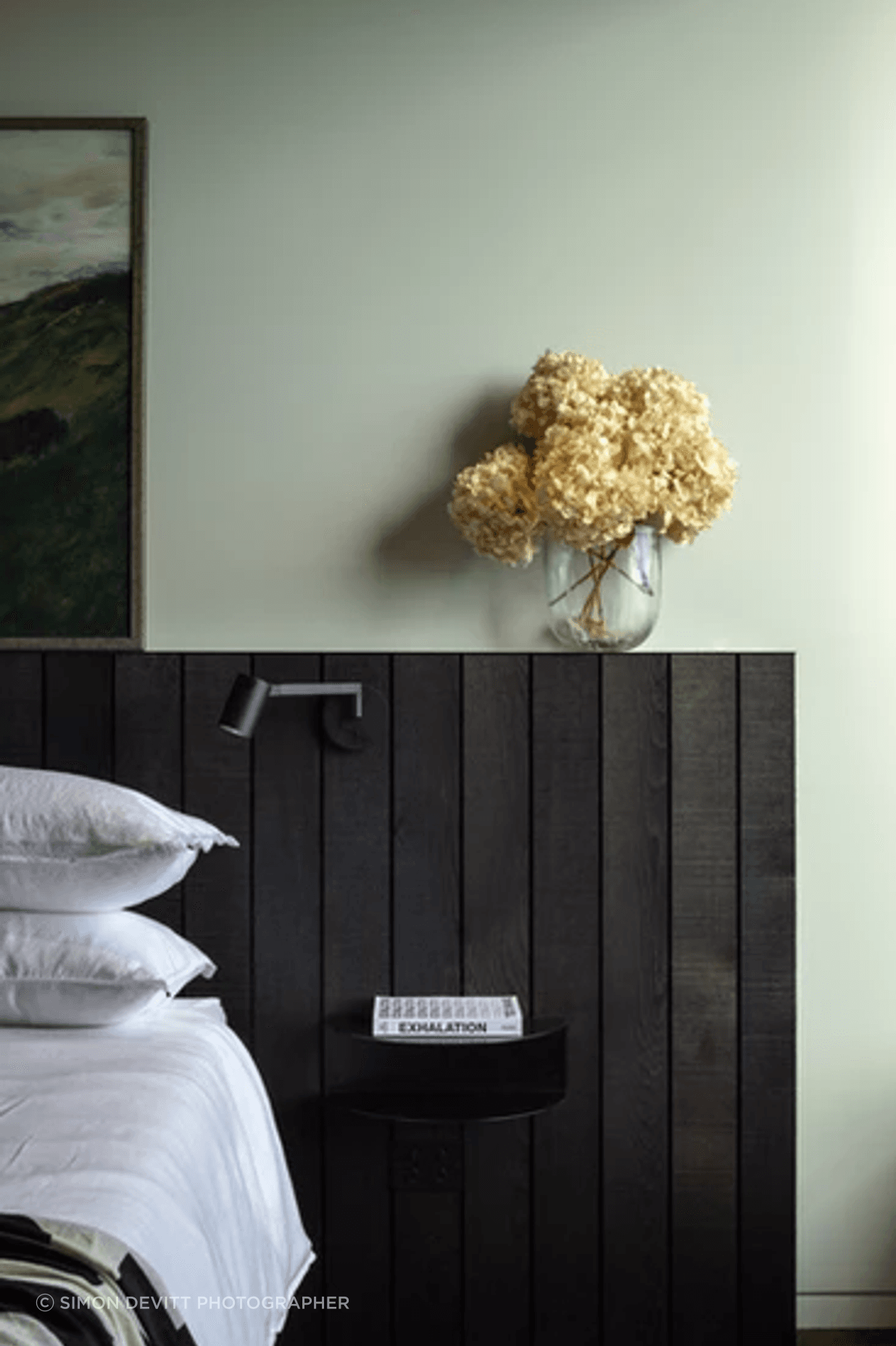 One of two master bedrooms that are both oriented to the views. The side table is from Made of Tomorrow.