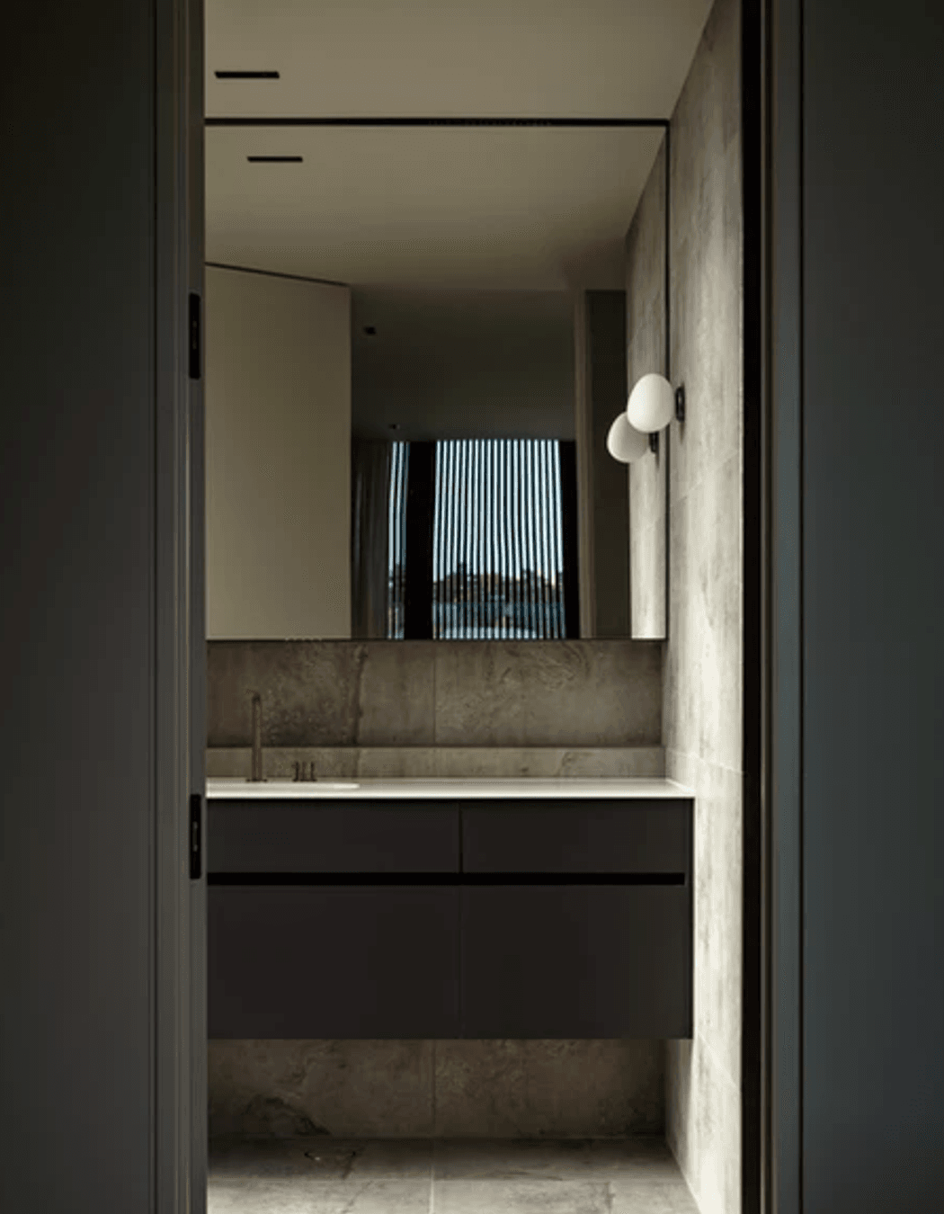 “We oriented the vanities in the ensuites so that the mirrors reflected the view behind,” says Evelyn. The lighting is from ECC.