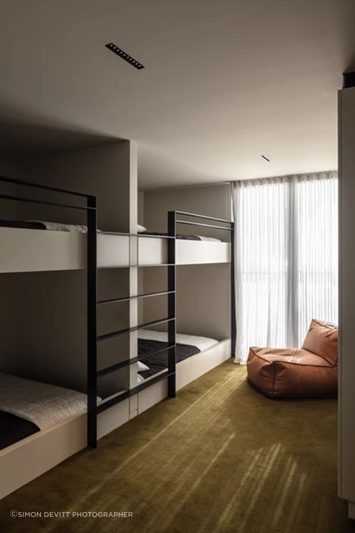The spacious bunk rooms are upstairs. Fiona chose the Sallée carpet to fit the surroundings. “We've got the green bush all around us. And then across the lake the hills are a really lush, khaki green.”