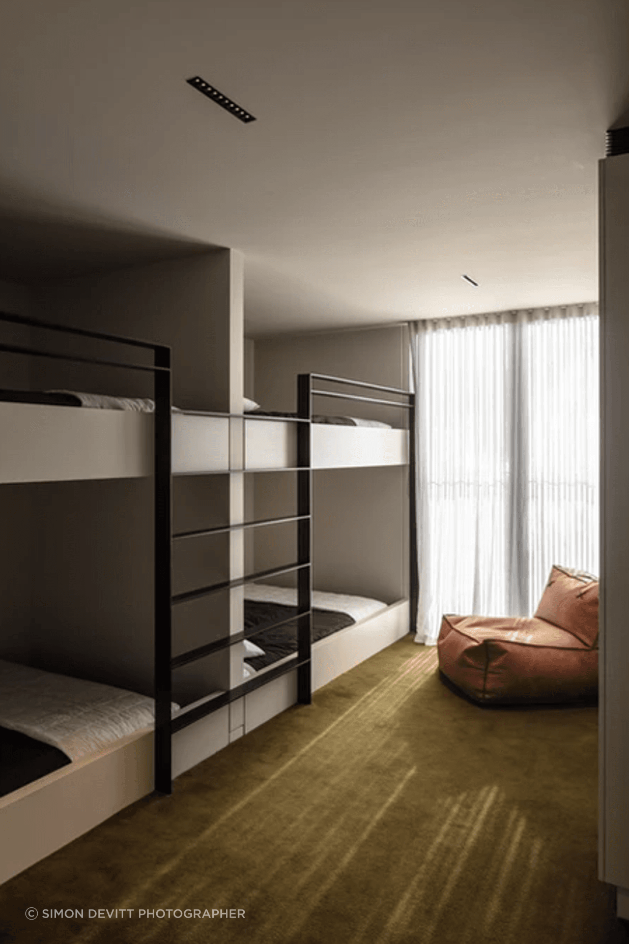 The spacious bunk rooms are upstairs. Fiona chose the Sallée carpet to fit the surroundings. “We've got the green bush all around us. And then across the lake the hills are a really lush, khaki green.”