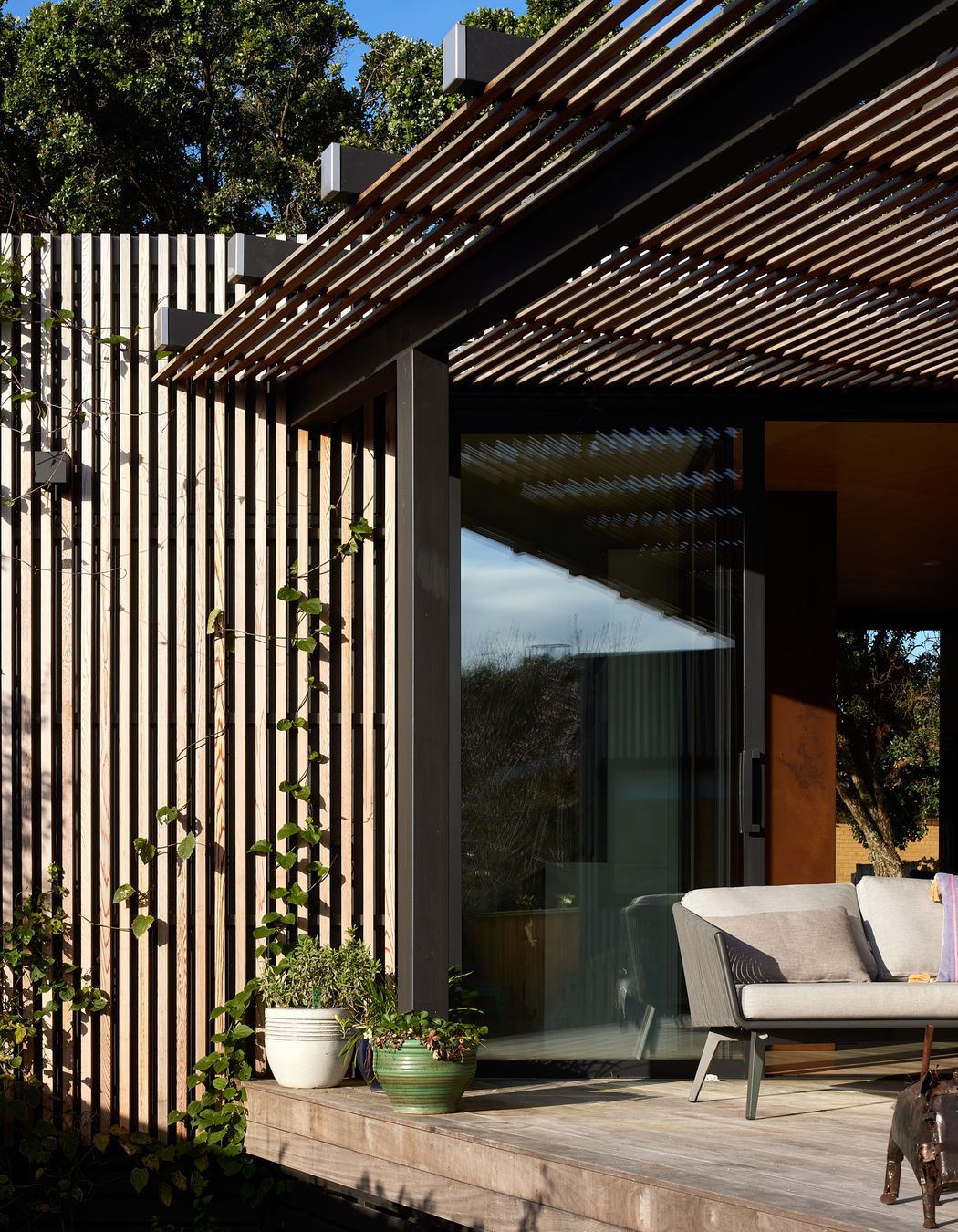 The timber battens double as a climbing frame for plants.