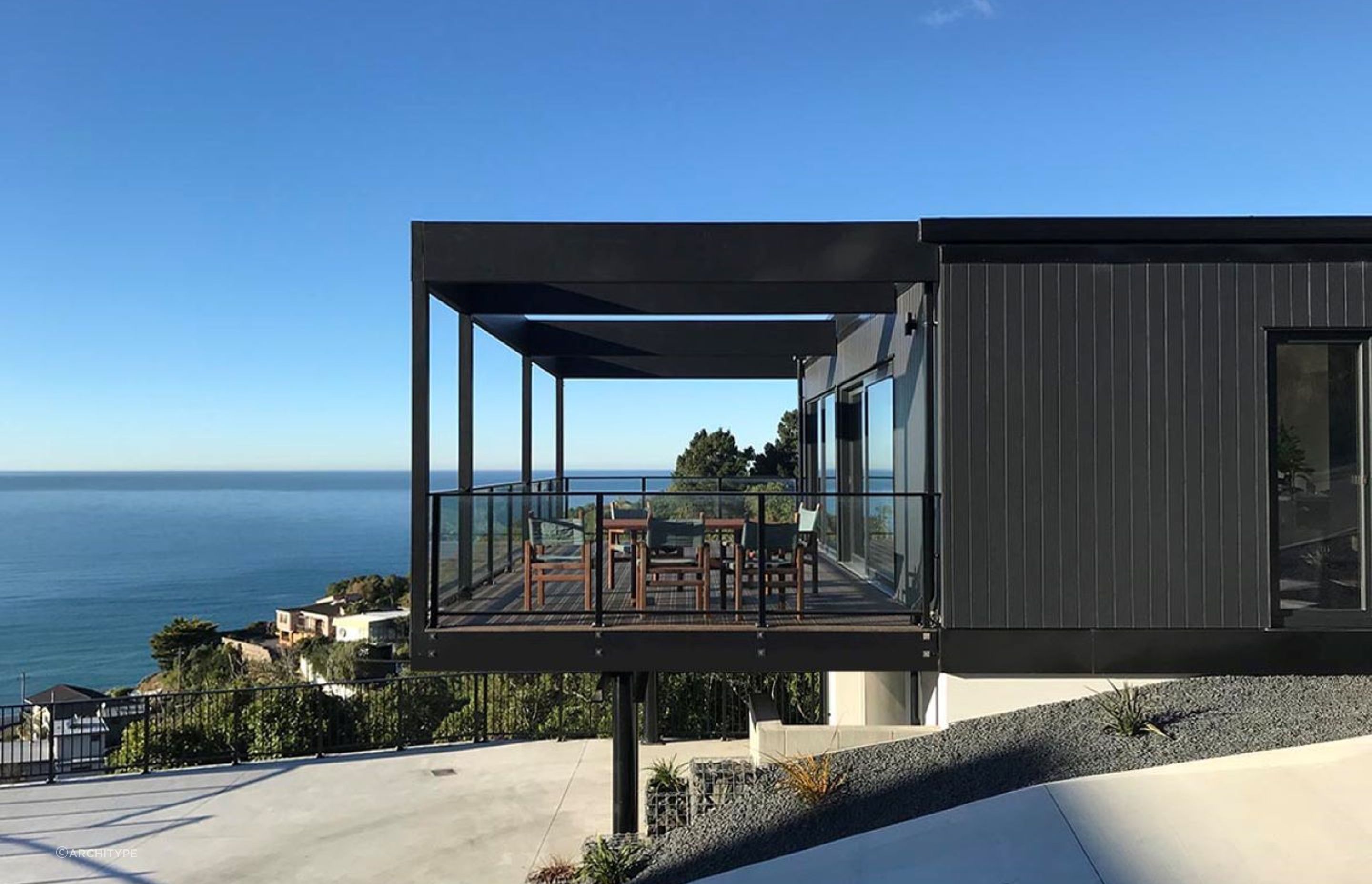 The home features cantilevered outdoor living space with movable shutters for privacy and shelter when needed.