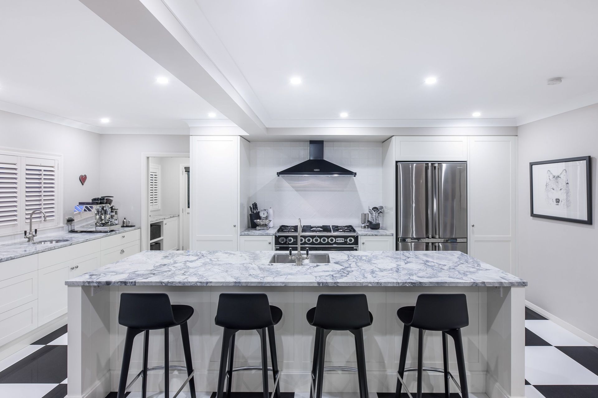 The black and white checkerboard flooring sets the scene in this stylish kitchen in St Heliers by Celia Visser Design.