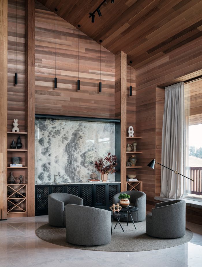 Onyx natural stone makes a statement in the bar area. The bench has a sink for easy access and cabinetry provides plenty of storage.