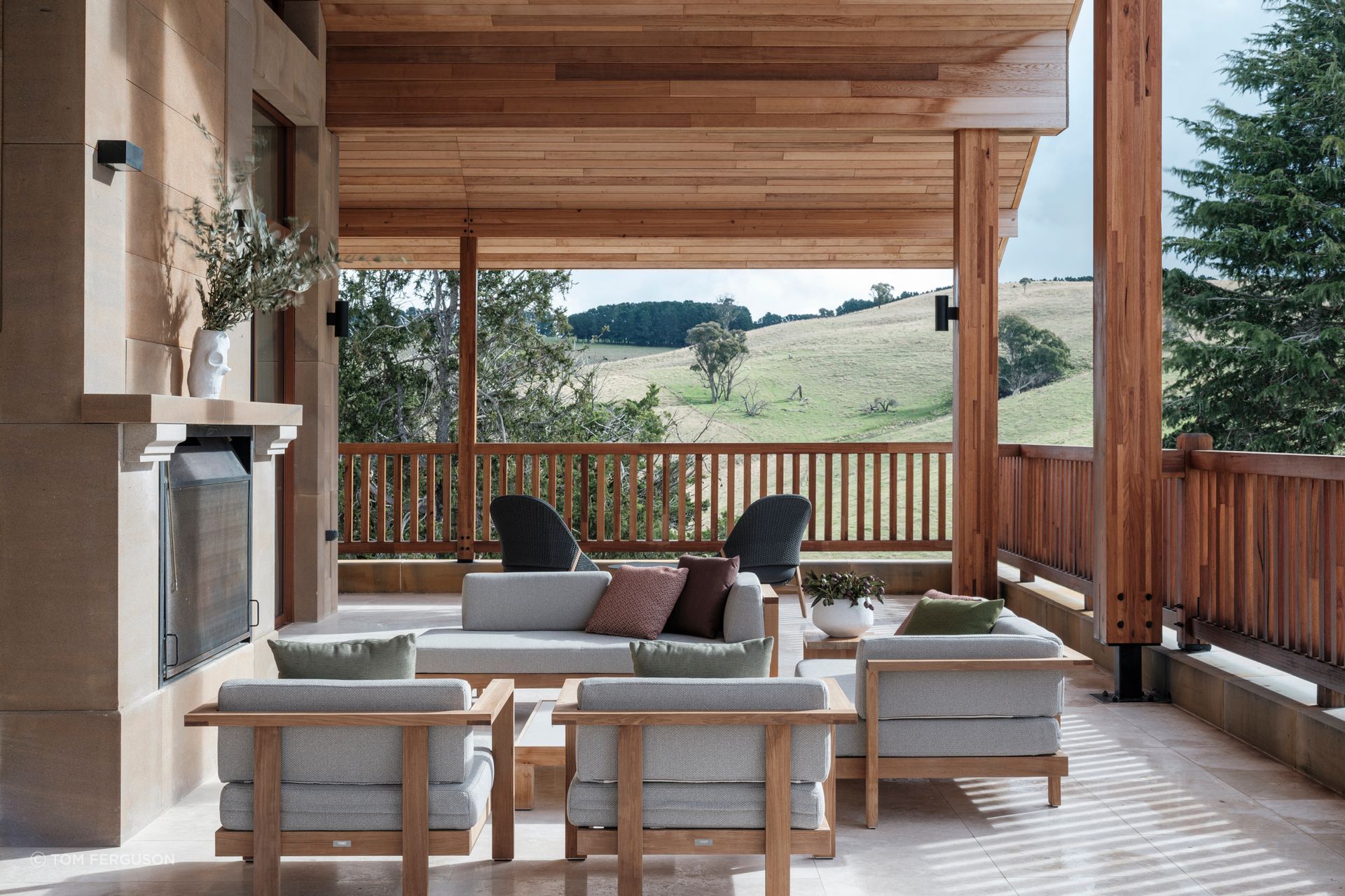 The two metre-wide sandstone outdoor fireplace mirrors the indoor fireplace.