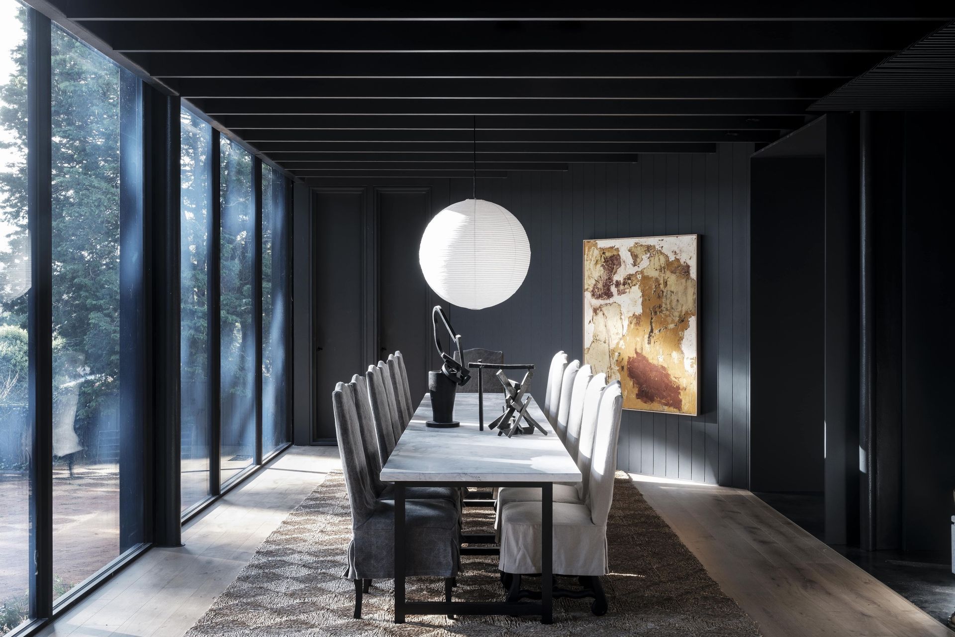 The dining room's restrained palette allows the artwork to do the talking.