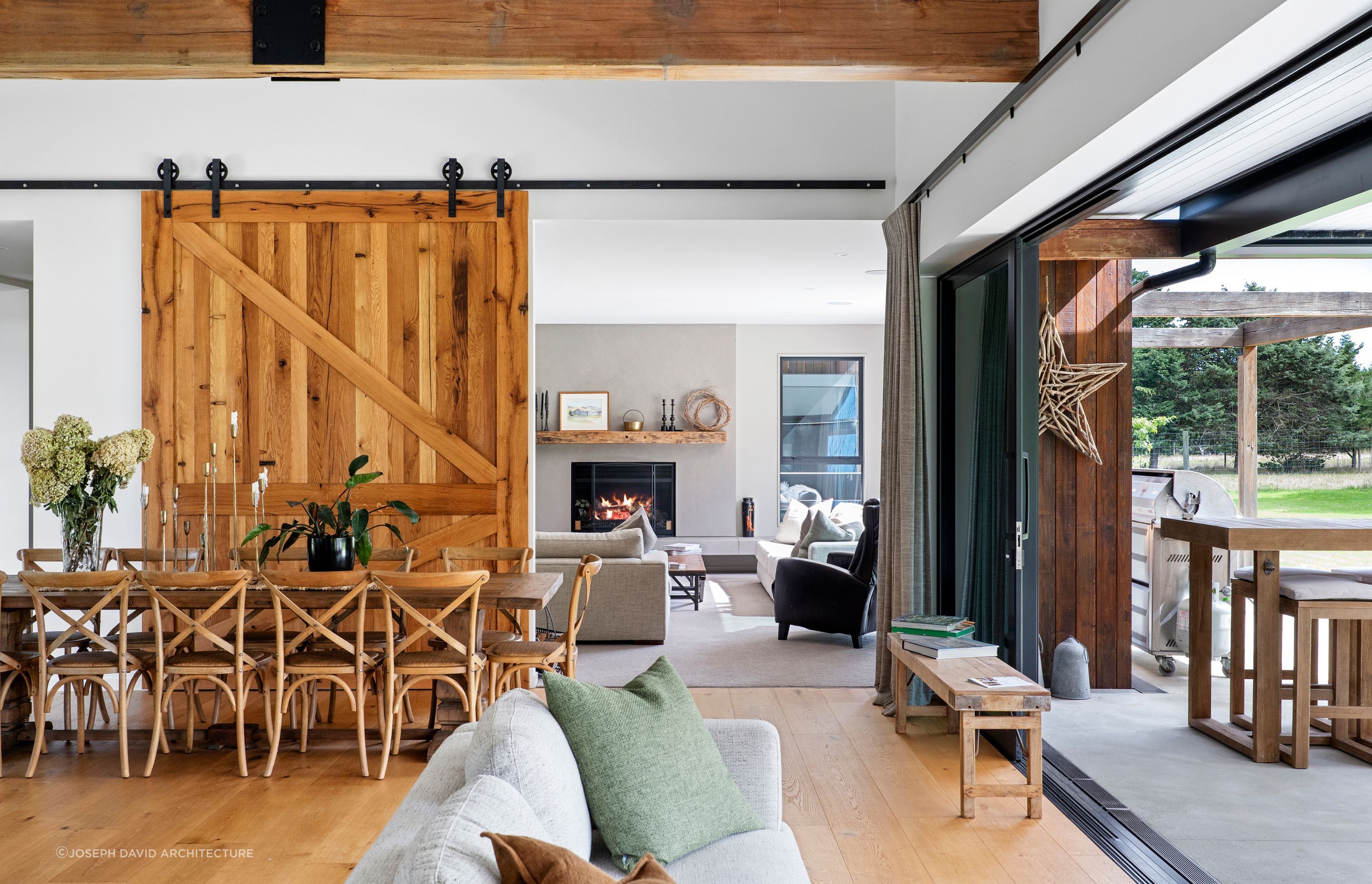 The timber barn door can be closed to enjoy the warmth of the fireplace in the lounge room.