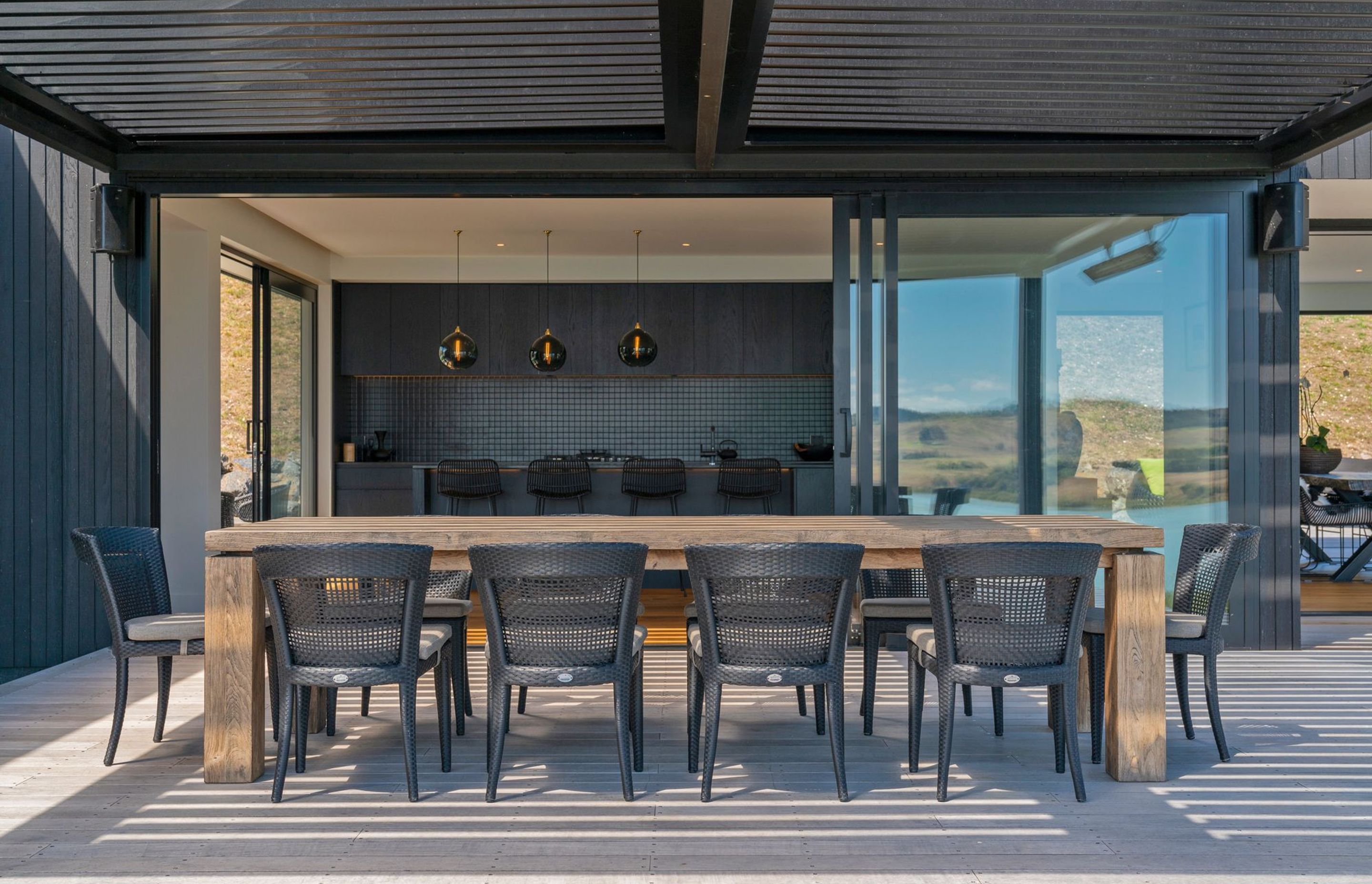 The open-plan kitchen, living and dining area opens out onto decking, complete with a louvre roof.