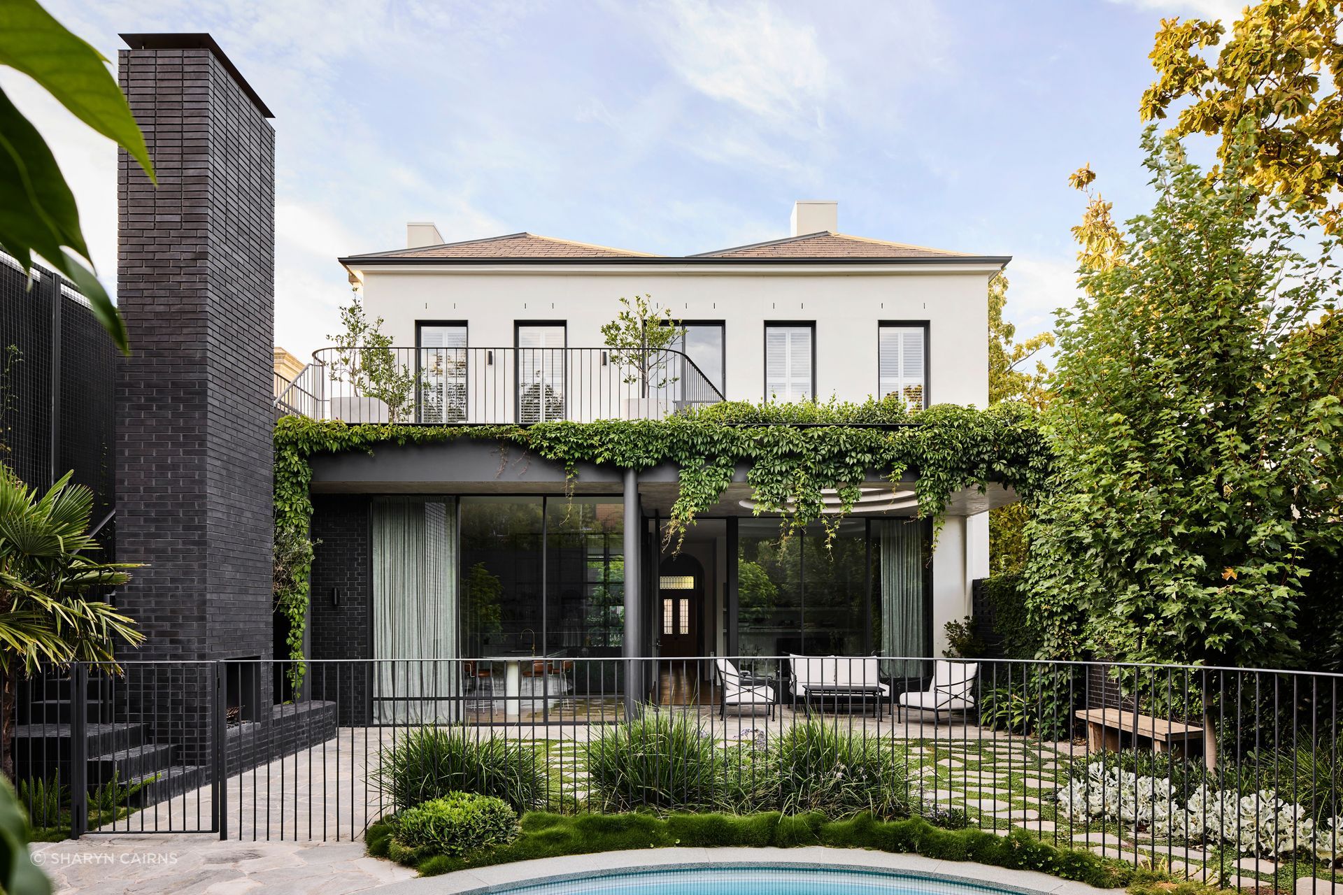 Brick and stone wrap the backyard and integrate seamlessly with the materiality of the original home.