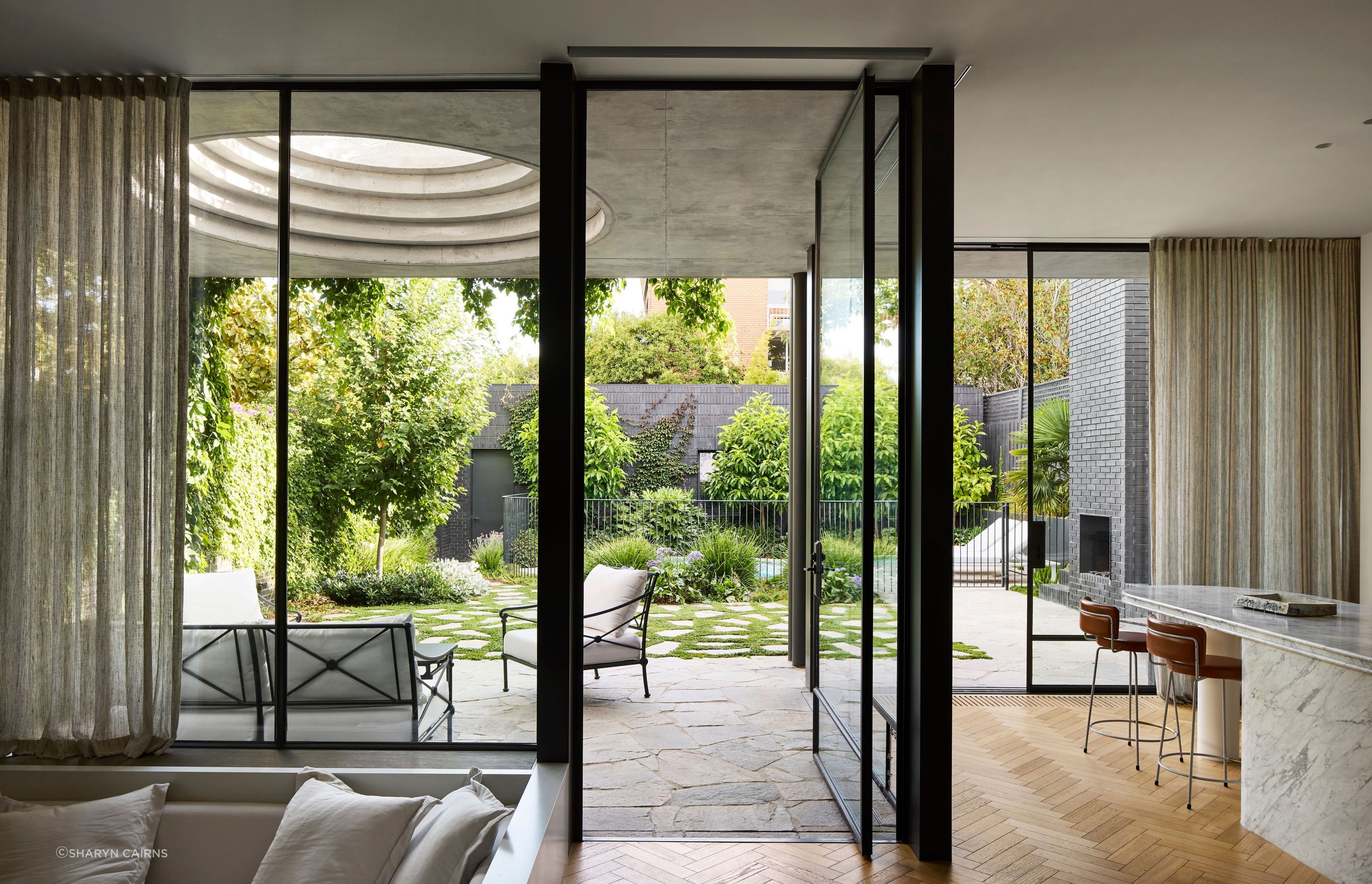 The new extension directly connects the kitchen and living spaces to an outdoor patio.