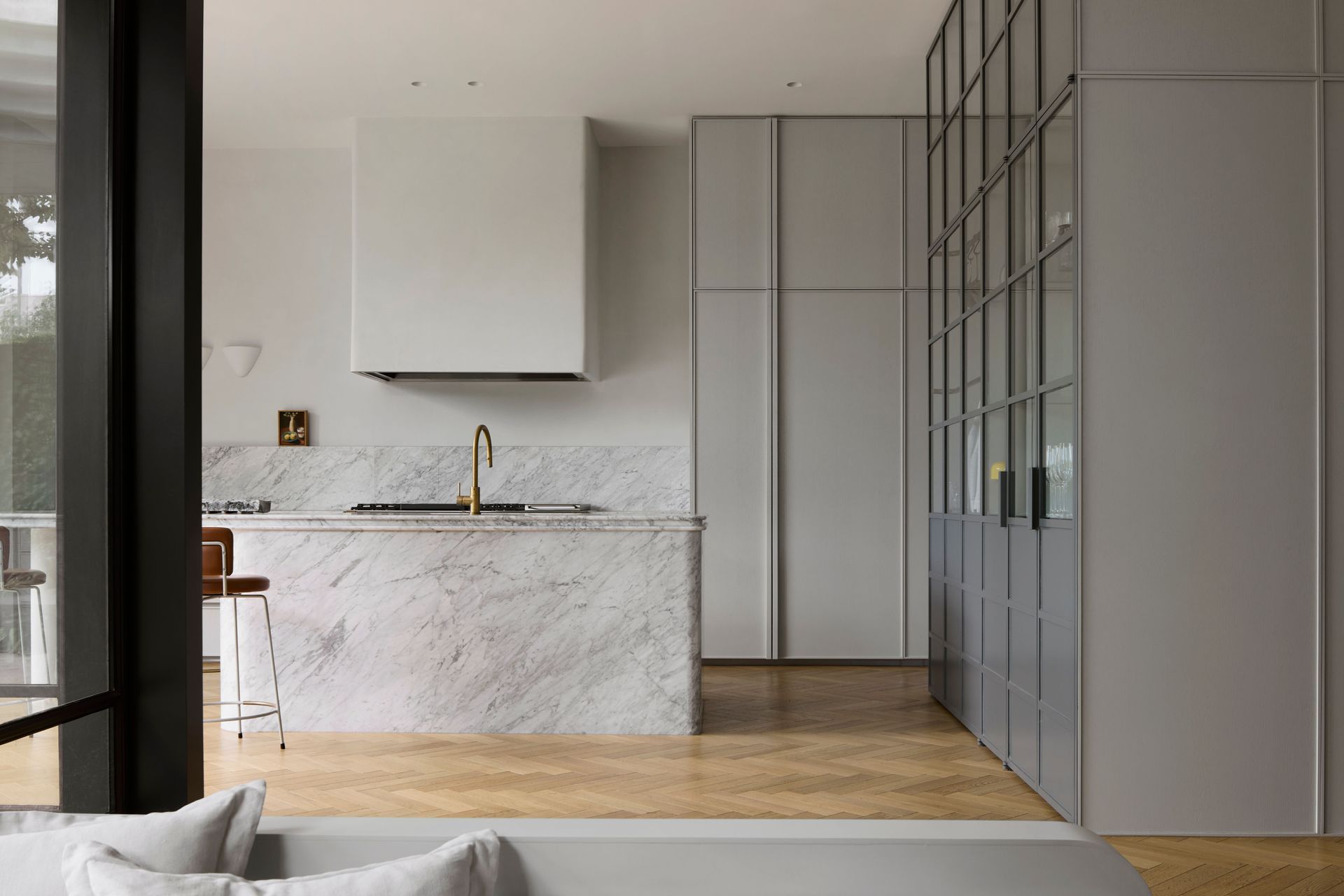 The kitchen is reimagined in soft grey tones and marble.