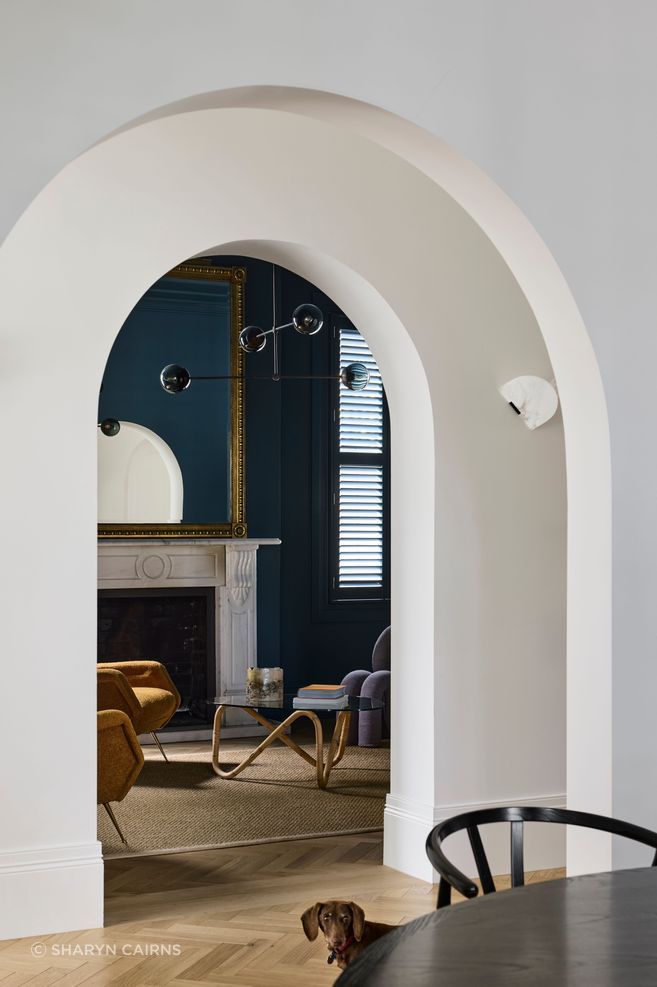 Arched openings from the hallway to the living spaces.