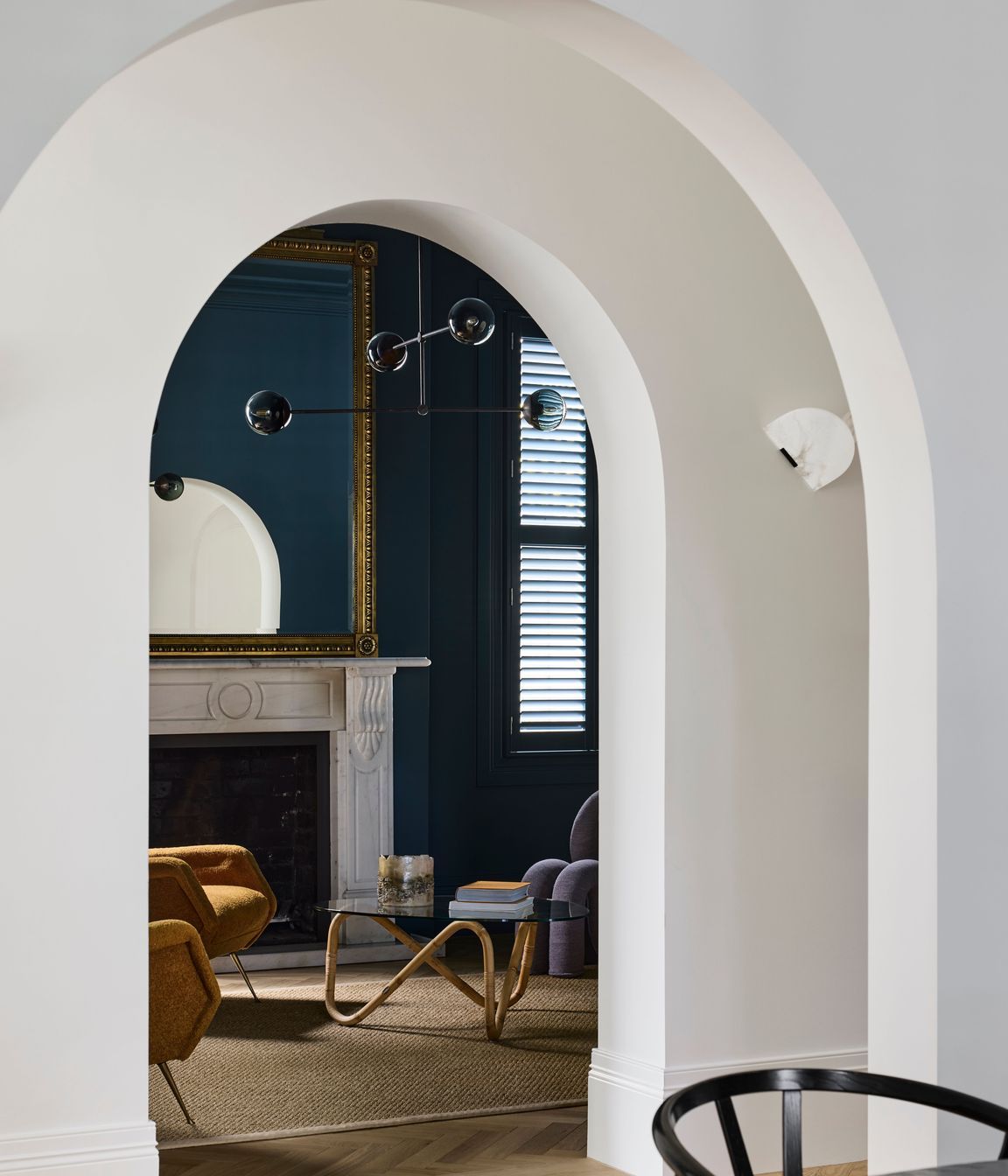 Arched openings from the hallway to the living spaces.