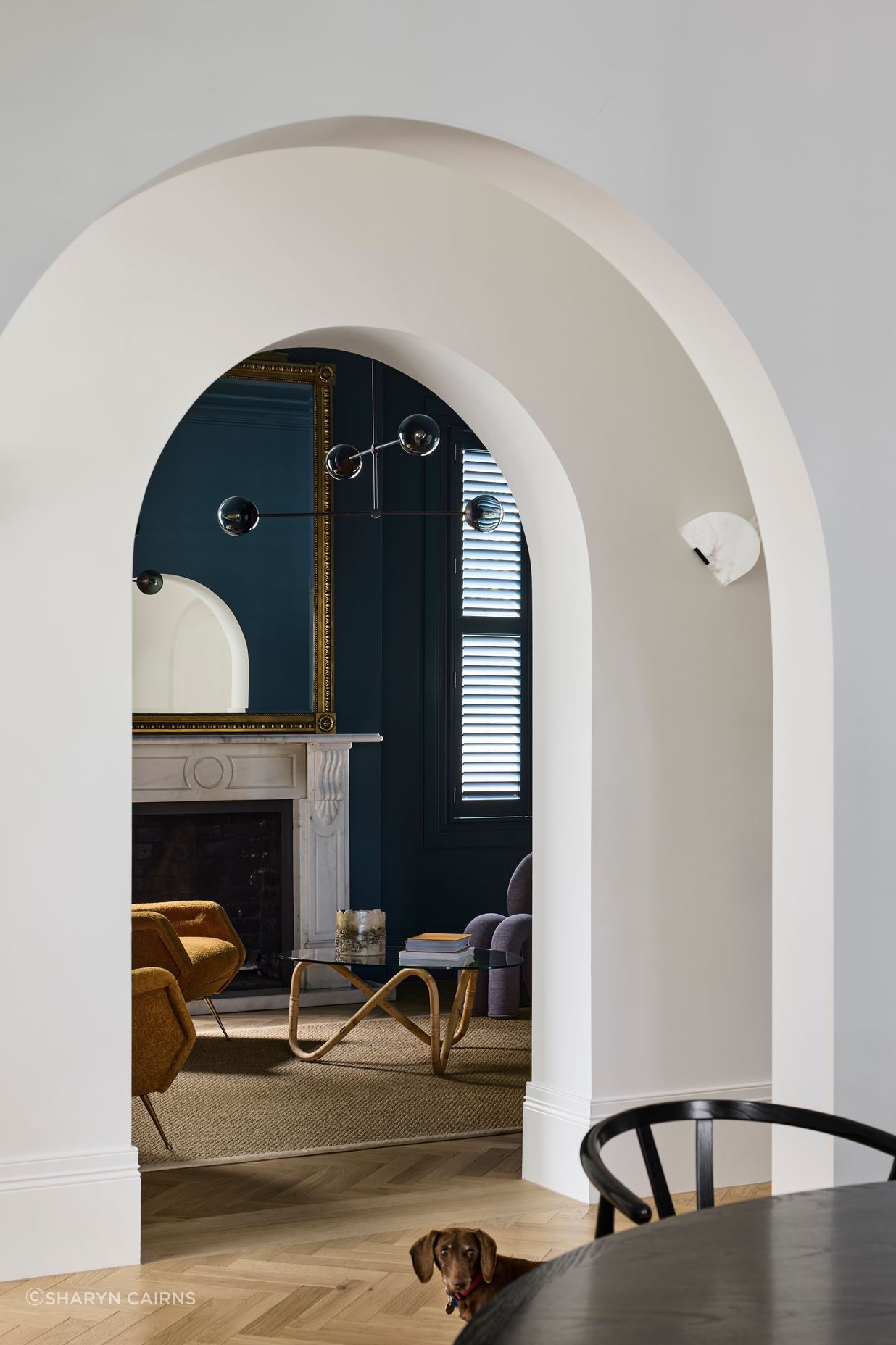 Arched openings from the hallway to the living spaces.