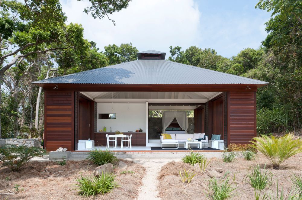 The exterior of this Tropical Beach House is designed to provide protection from the elements. Photographer: Willem Rethmeier