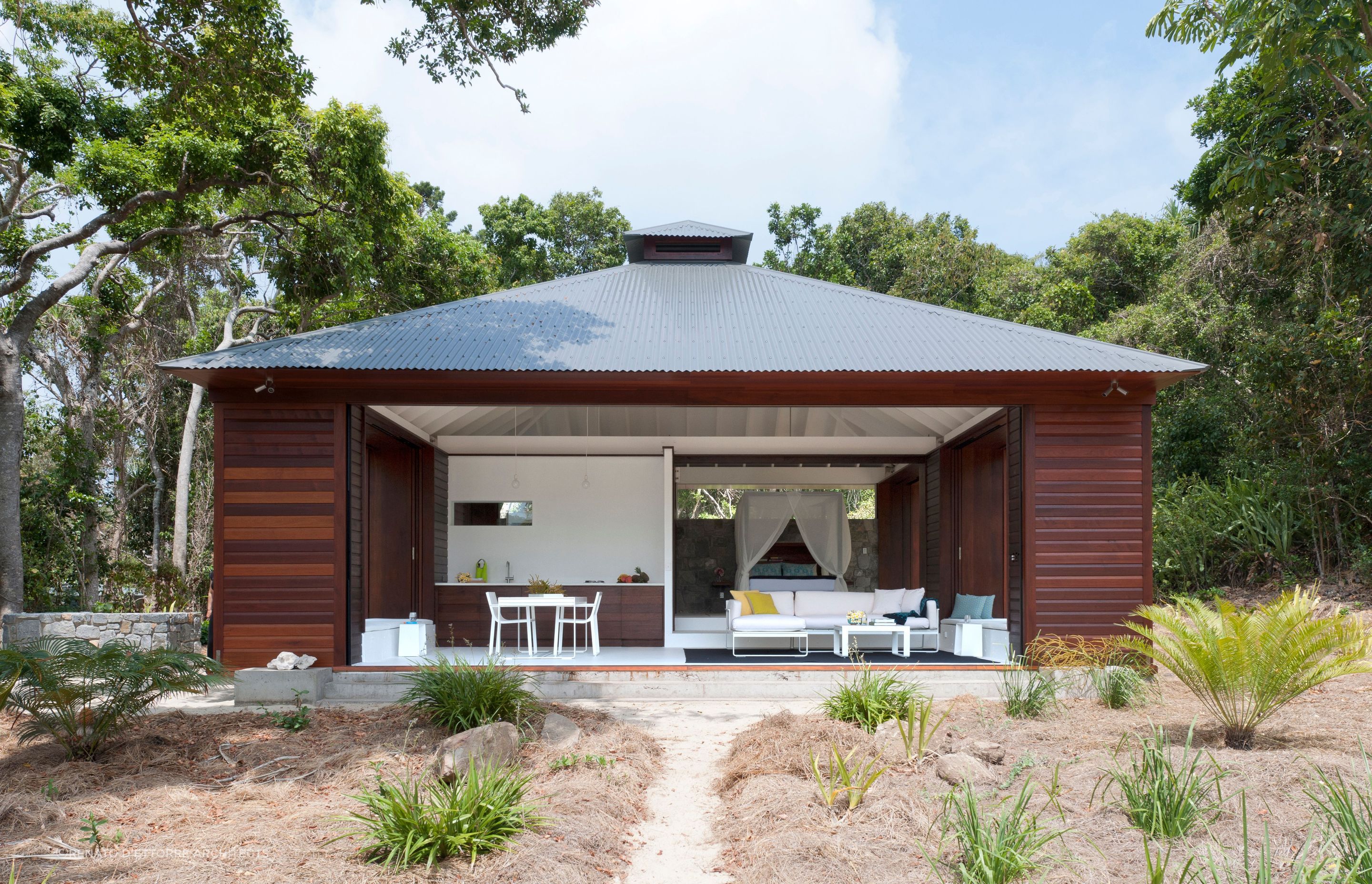 The exterior of this Tropical Beach House is designed to provide protection from the elements. Photographer: Willem Rethmeier