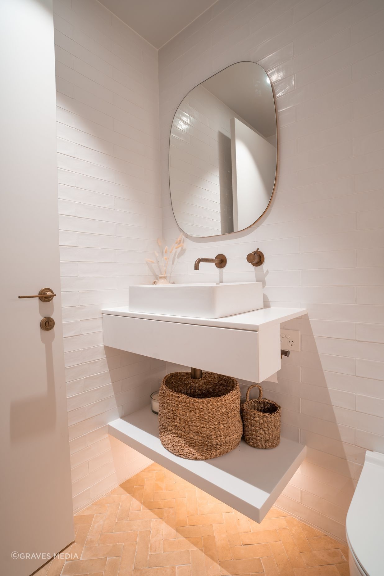 Handmade terracotta floor tiles bring warms and texture to the master ensuite.