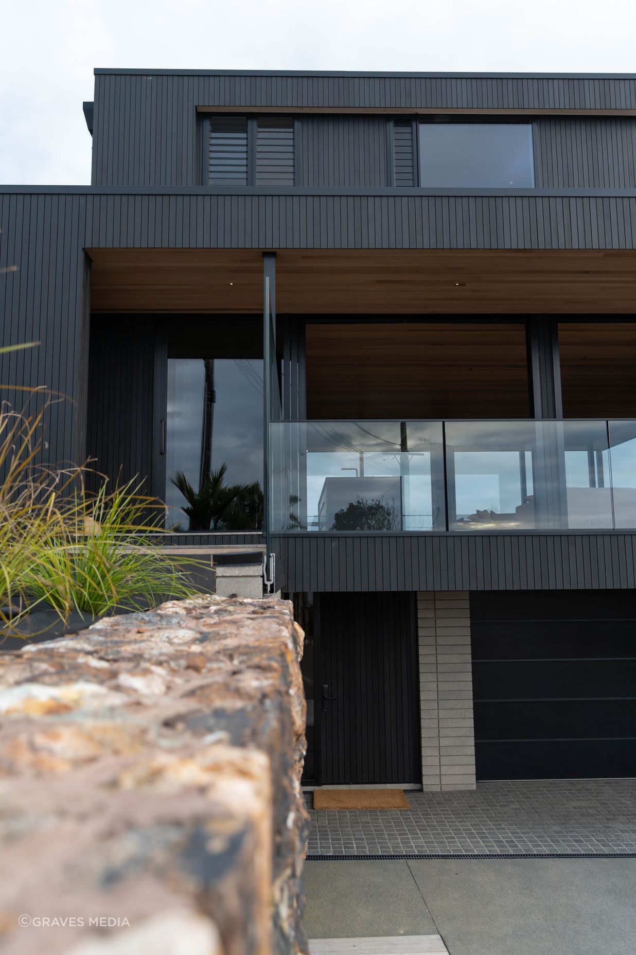 The exterior materiality complements the natural surrounds.