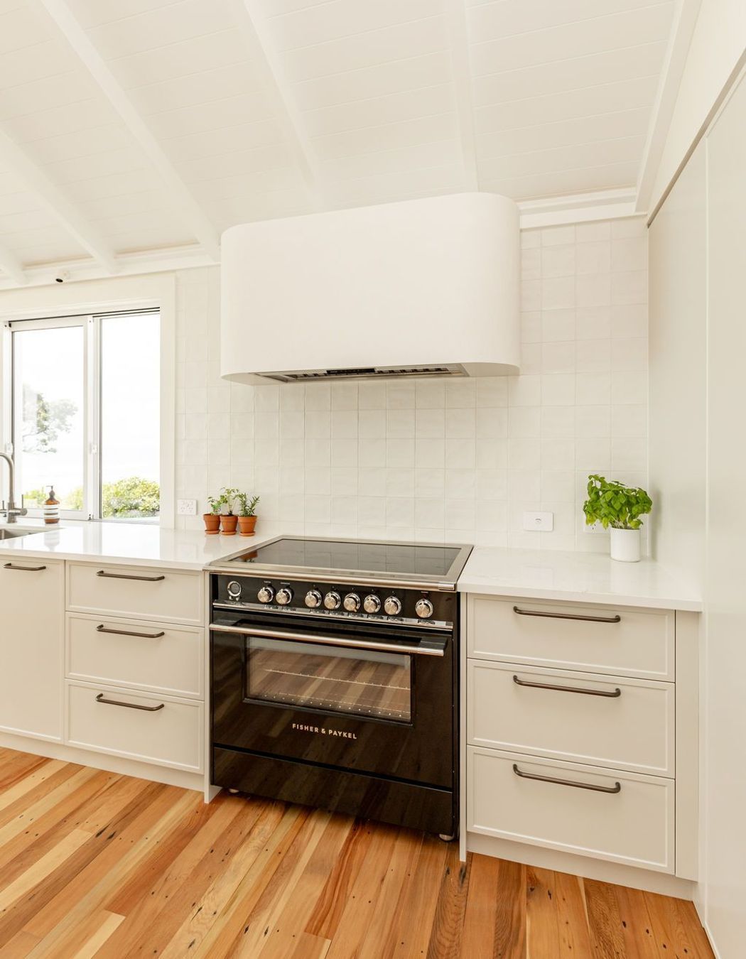 “Functionality is paramount in this bespoke kitchen - integrated Fisher &amp; Paykel appliances ensure that every culinary need is met with ease, while the sleek, modern lines of the appliances complement the kitchen’s overall aesthetic.”