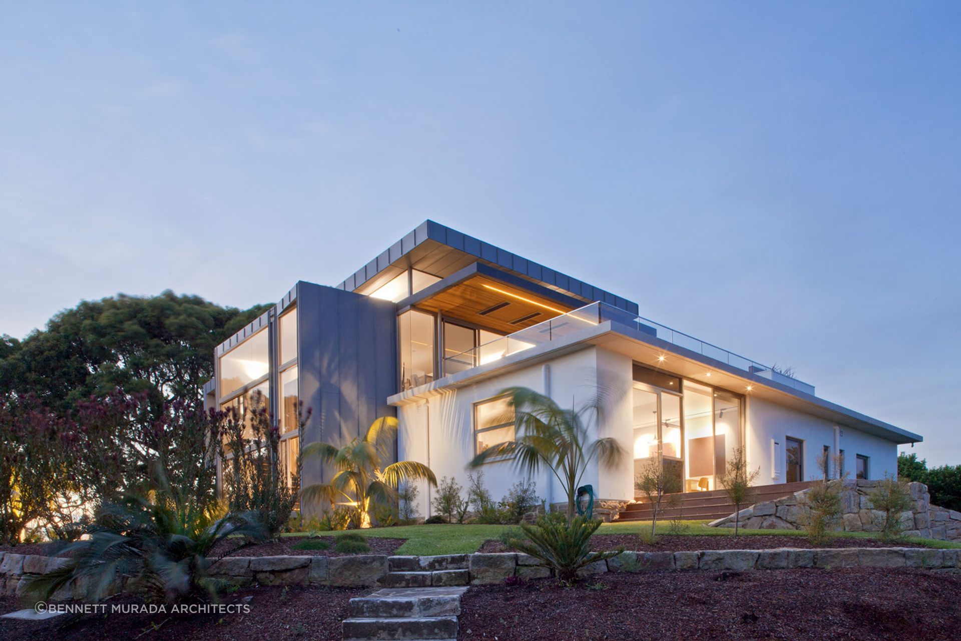 Whale Beach House's interior lighting blends with abundant natural light, creating a cohesive and inviting atmosphere. Photographer: Simon Wood.