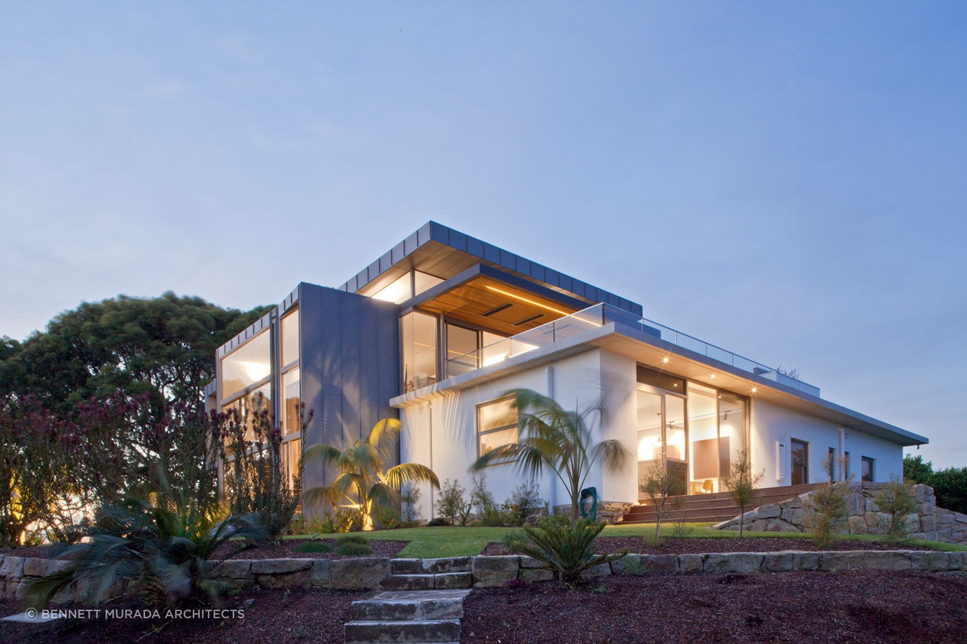 Whale Beach House's interior lighting blends with abundant natural light, creating a cohesive and inviting atmosphere. Photographer: Simon Wood.