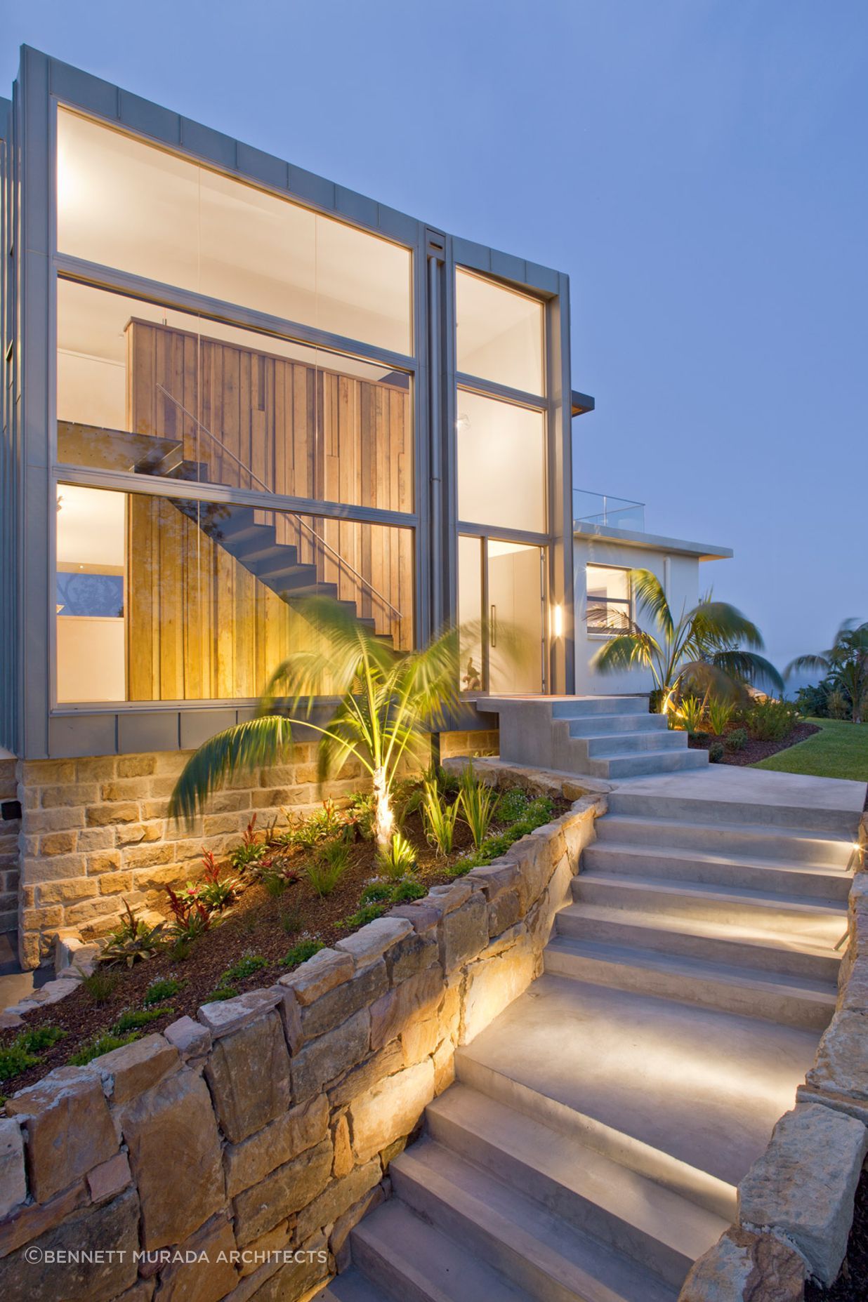 The property features large windows, which help to maximise natural light in the home. Photographer: Simon Wood.