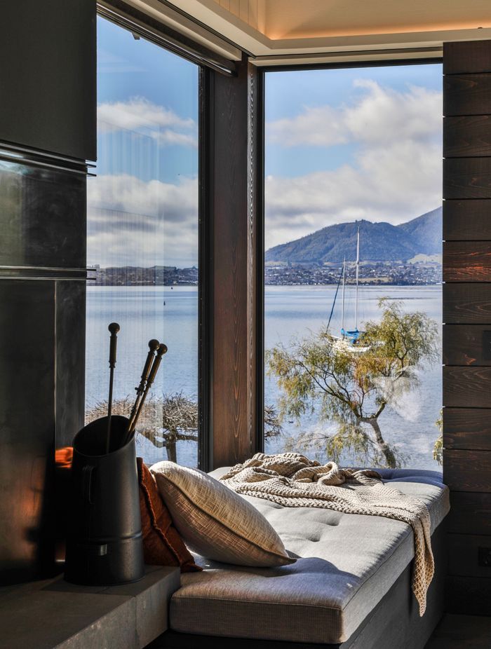 Next to the living room fireplace, the homeowners can retreat to the window seat to take in the view.