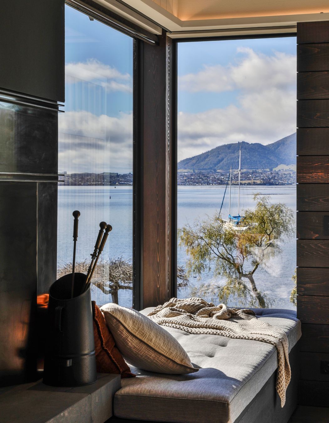 Next to the living room fireplace, the homeowners can retreat to the window seat to take in the view.