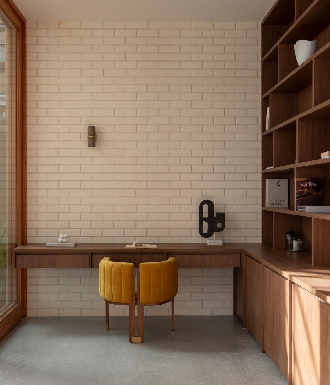 Brick pairs with bespoke cabinetry in the study.