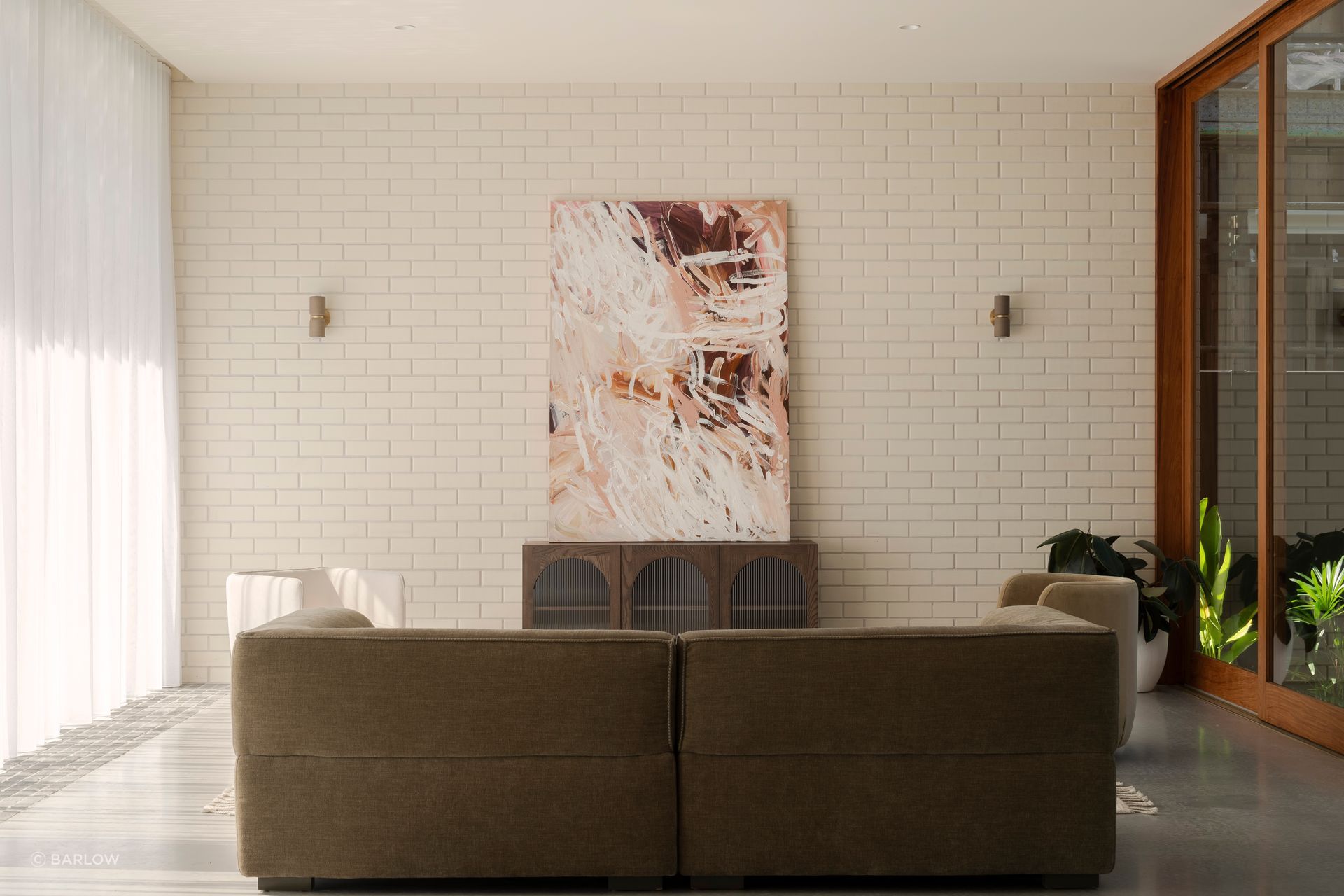 The lounge area enjoys natural light from the atrium and the north-facing floor-to-ceiling glazing.