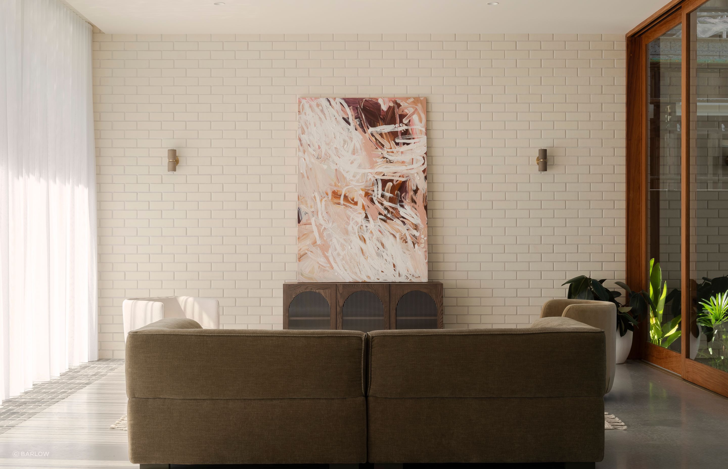 The lounge area enjoys natural light from the atrium and the north-facing floor-to-ceiling glazing.
