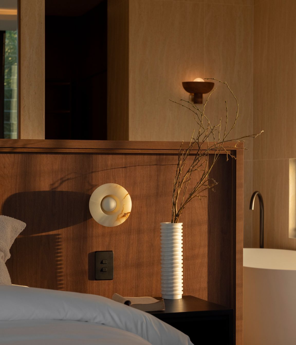 The master is warm and textural with a beautiful material selection.