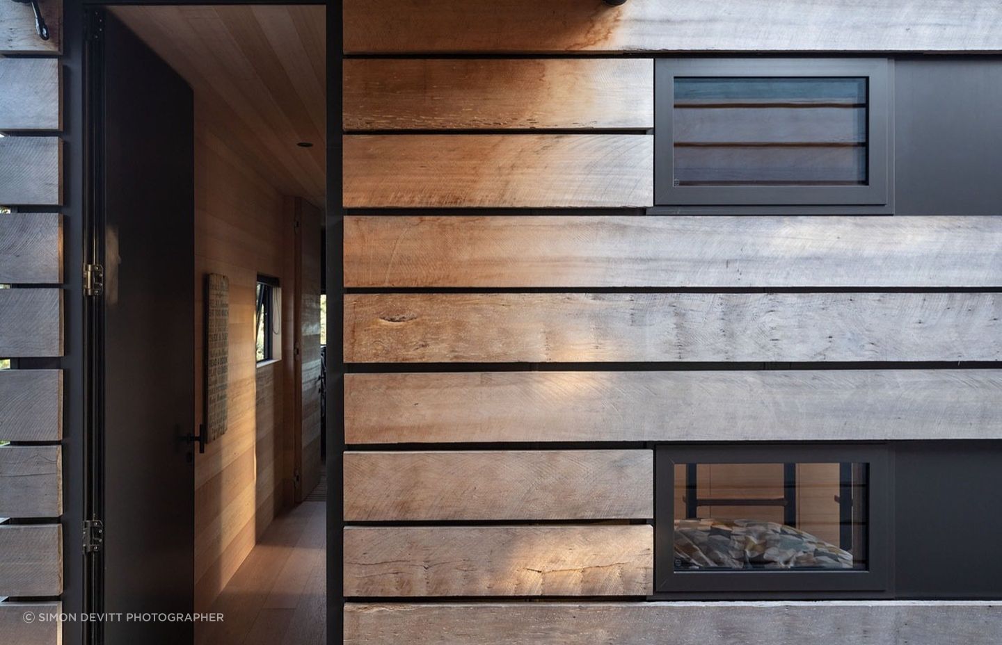 Powder coated black steel contrasts with timber throughout.