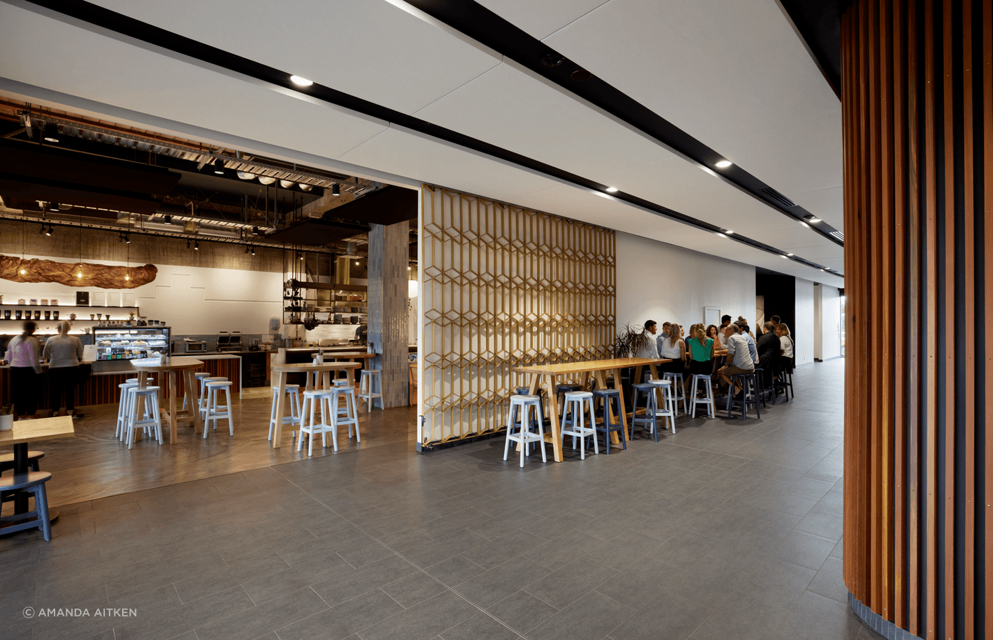 Throughout the building, the decorative facade treatment is replicated inside; here it offers a screen to close off the cafe.