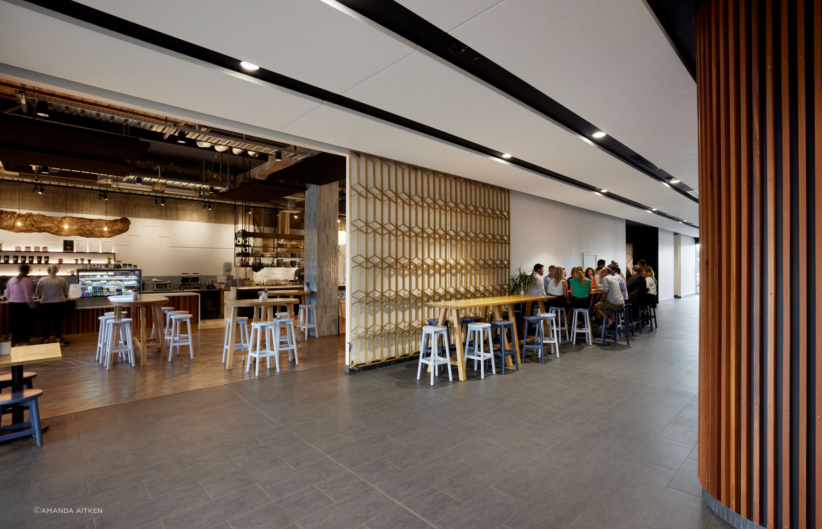 Throughout the building, the decorative facade treatment is replicated inside; here it offers a screen to close off the cafe.