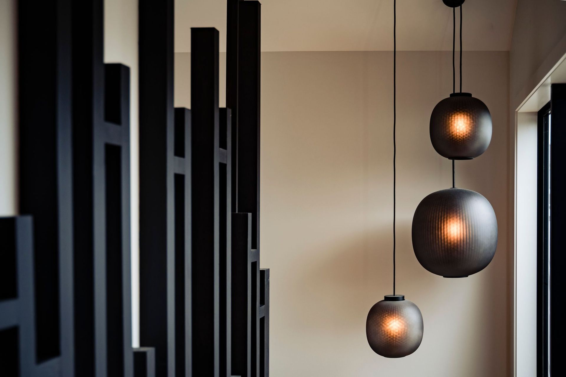 Pendants from Simon James complement the black of the staircase.
