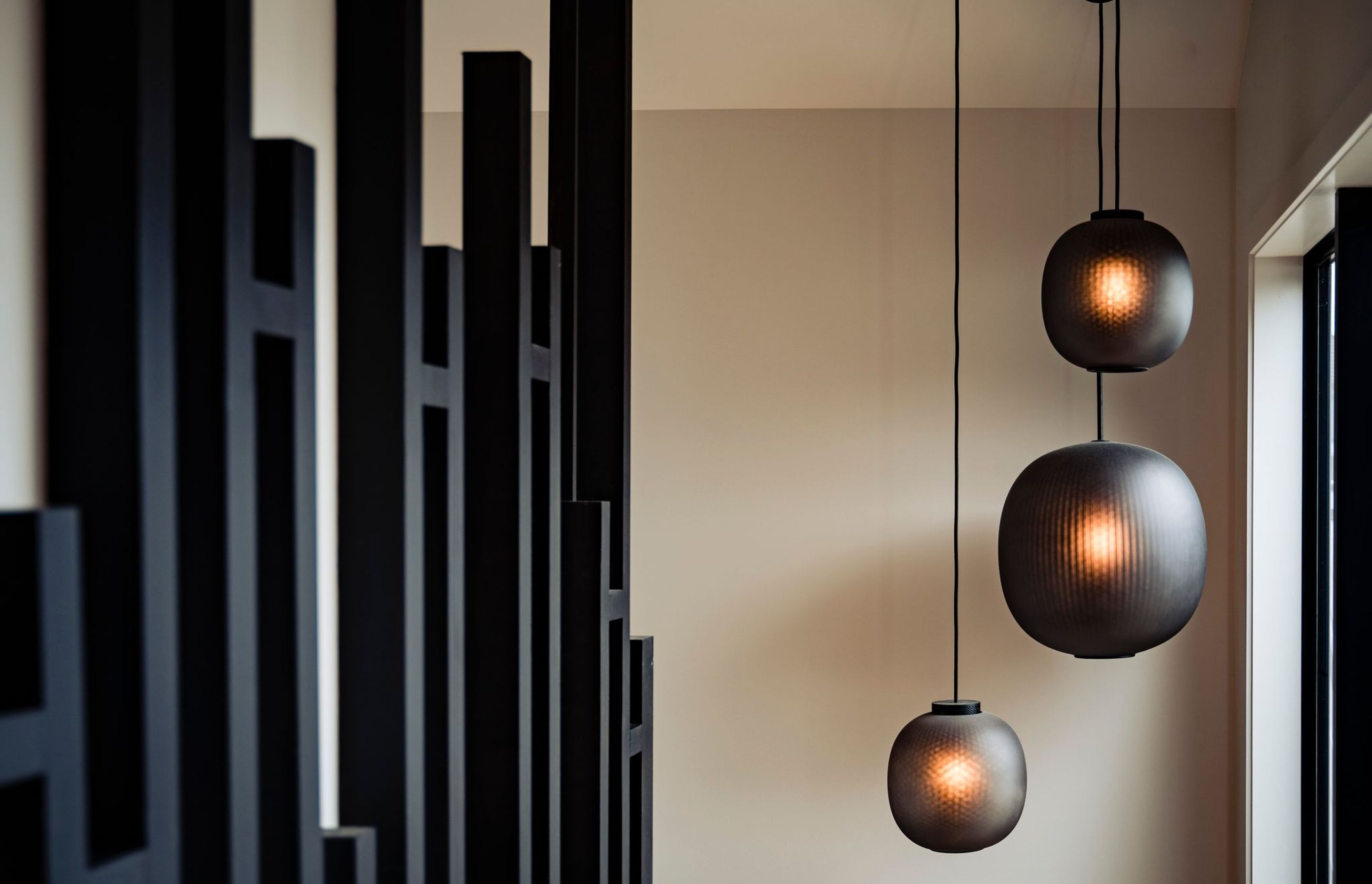 Pendants from Simon James complement the black of the staircase.