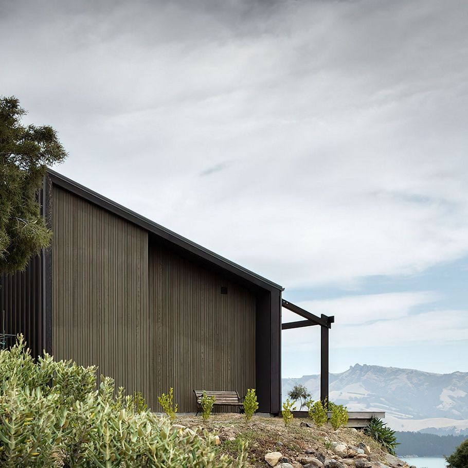 A cave-inspired home rising from a lava flow embankment