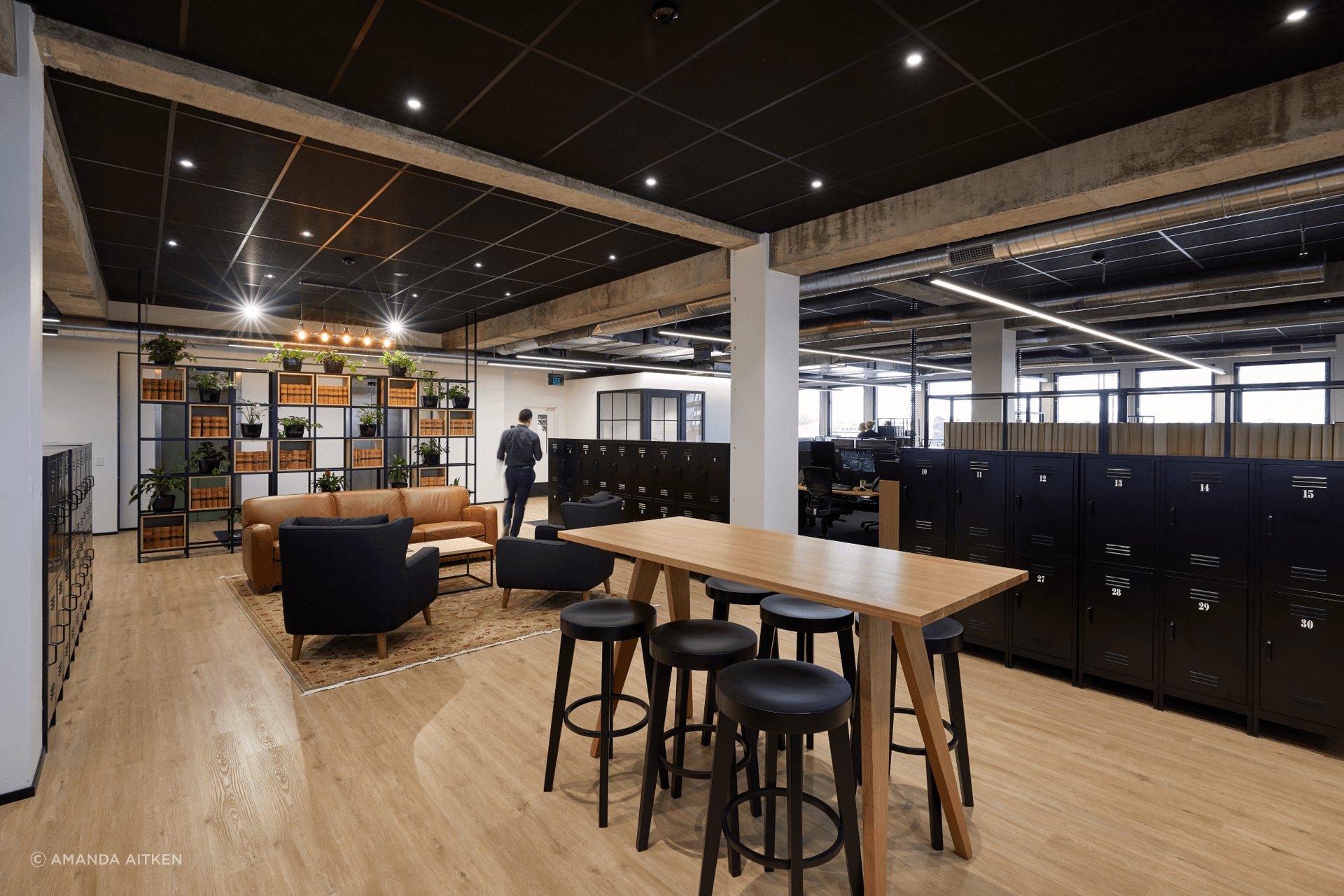 On the floor below, a modern industrial aesthetic was embraced, with concrete forms and timber beams left exposed.