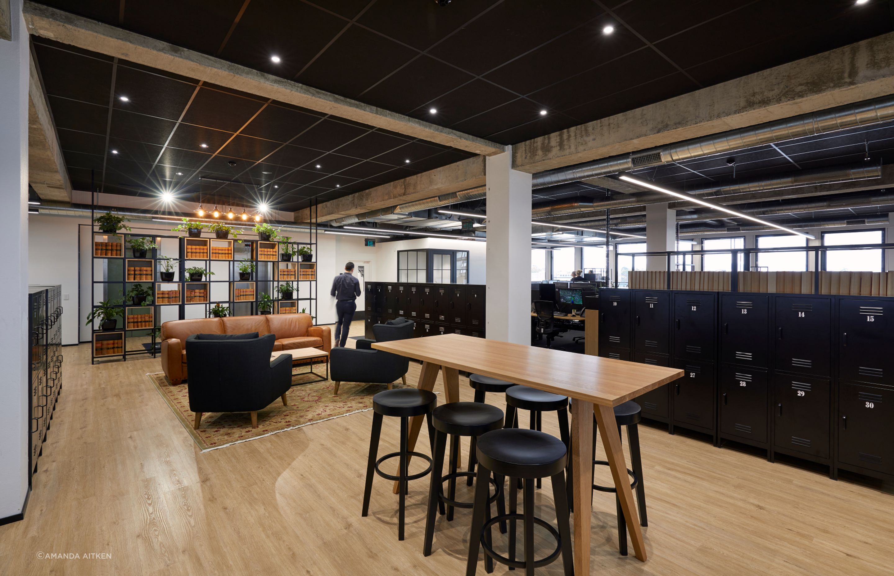 On the floor below, a modern industrial aesthetic was embraced, with concrete forms and timber beams left exposed.