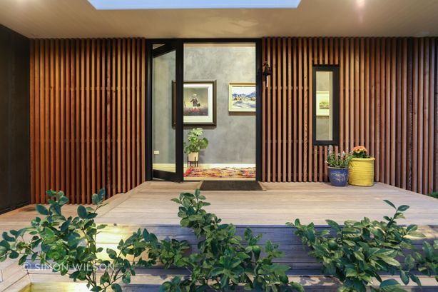 The entryway and living areas are clad in Venetian plaster.