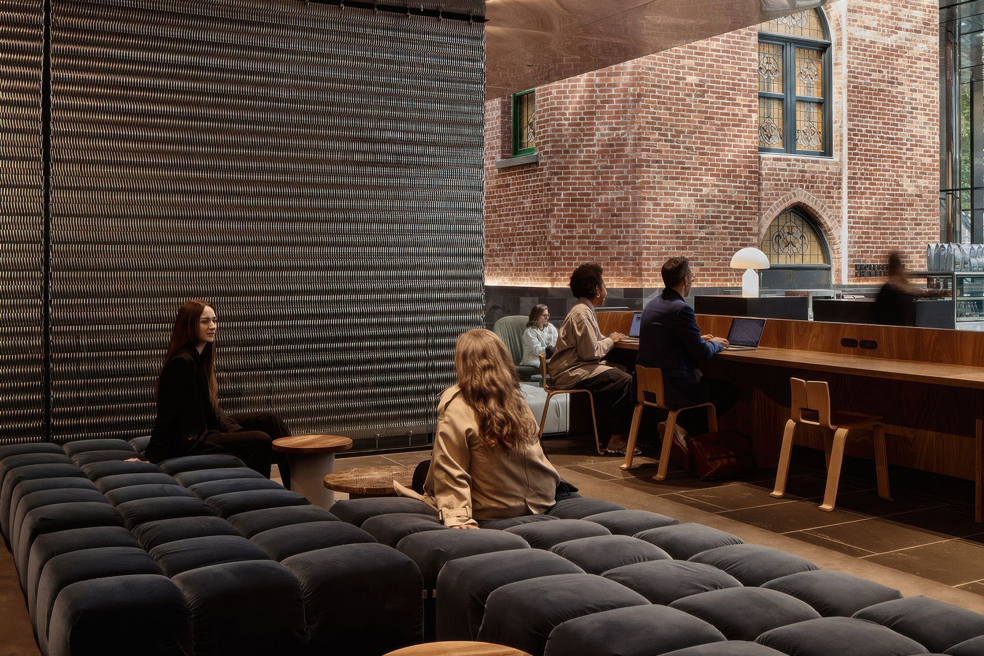 Relaxing on the mezzanine with views to the surrounding historic buildings, here B&B Italia Tufty-Time in soft grey velvet provides a place to catch up with friends and colleagues.