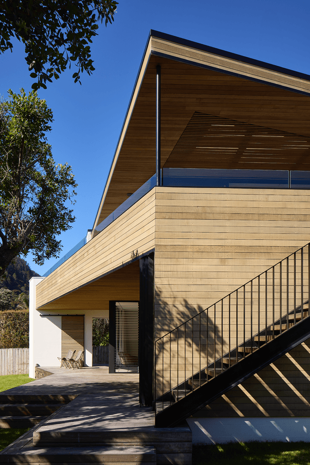 The wide eaves splay out in a variety of angles, echoing the silhouette of the adjacent hillside.