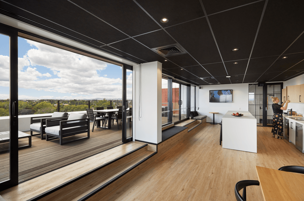 The kitchen space offers plenty of room for staff to congregate and opens up to the deck.