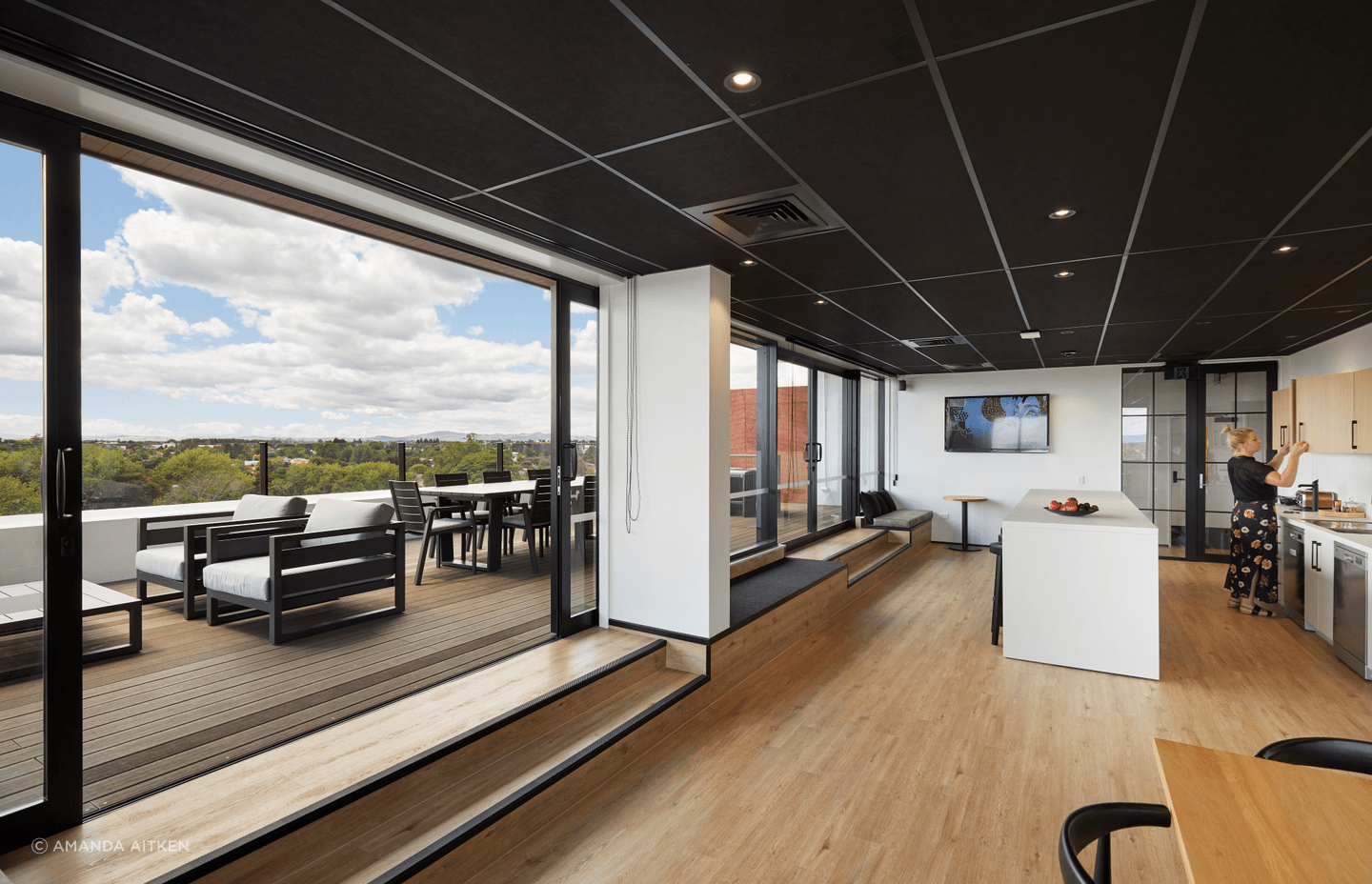 The kitchen space offers plenty of room for staff to congregate and opens up to the deck.