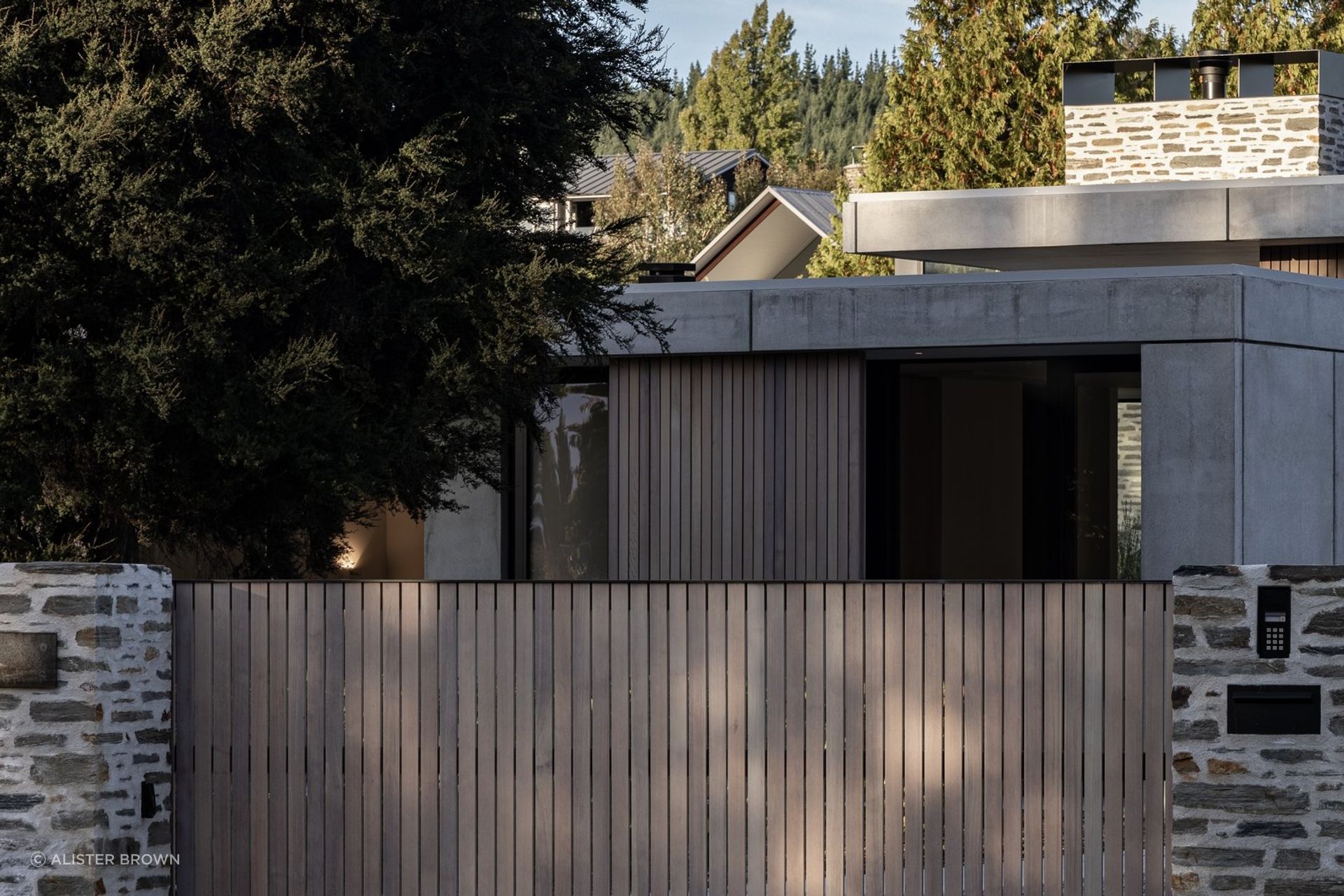 Beacon Point Road is dotted with homes, but Koroa House's protective form and material palette curate a sense of privacy.