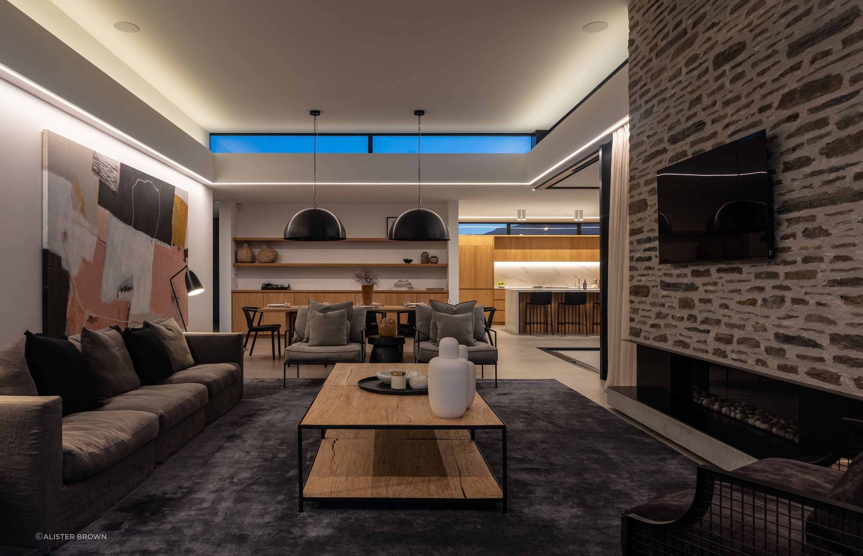 Upstairs, on the third level, a tranquil living, kitchen and dining area, courtyard, and guest room await.